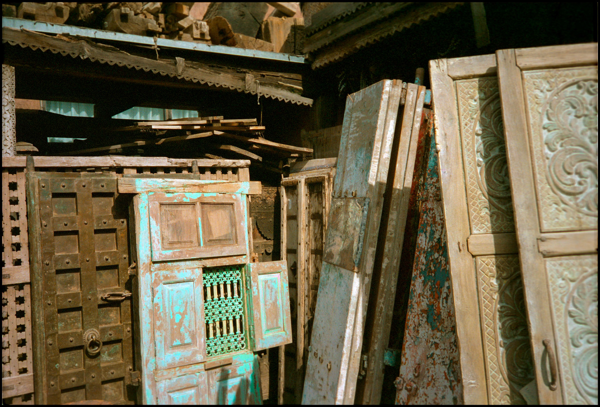 A vintage view of a group of recycled antique doors for sale in a public market in downtown Santa Fe New Mexico USA 1993