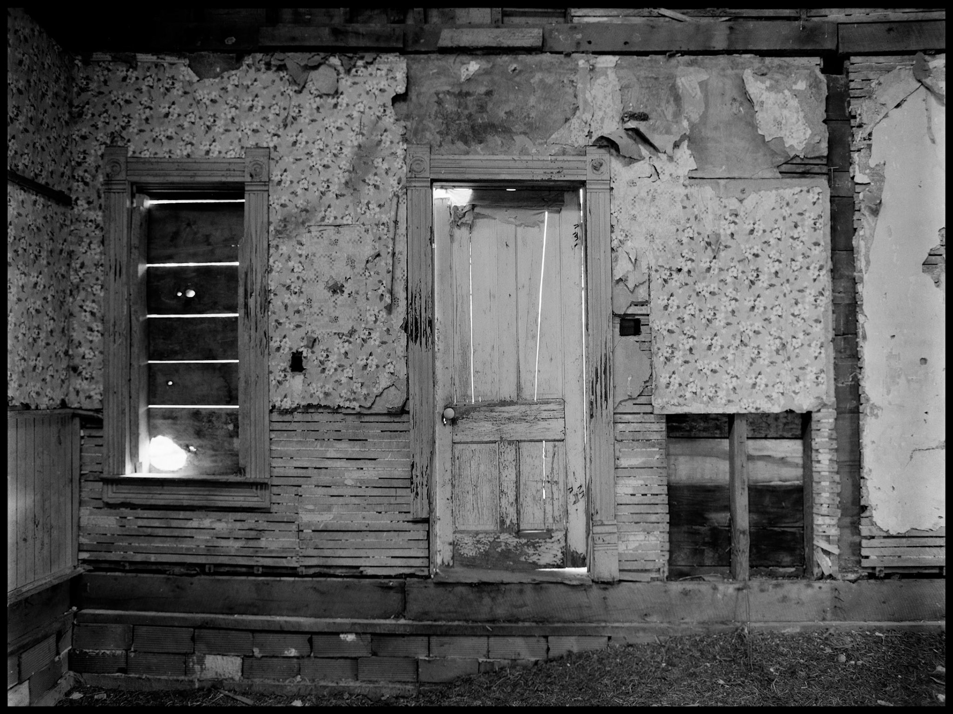 The interior of an abandoned house in an advanced state of decay. Near Pennville, Missouri USA, 1979.
