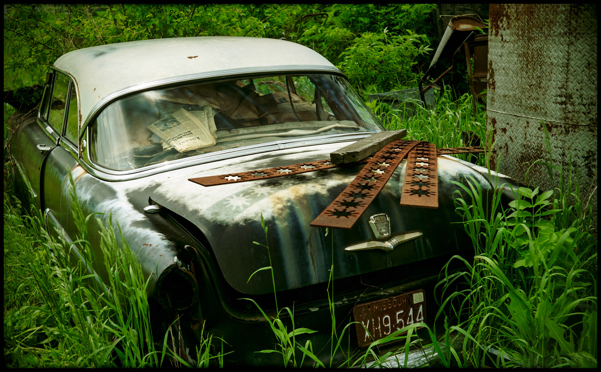 A salvaged classic 1953 Ford car covered with scrap steel and filled with memorabilia. Green City, Missouri 1990