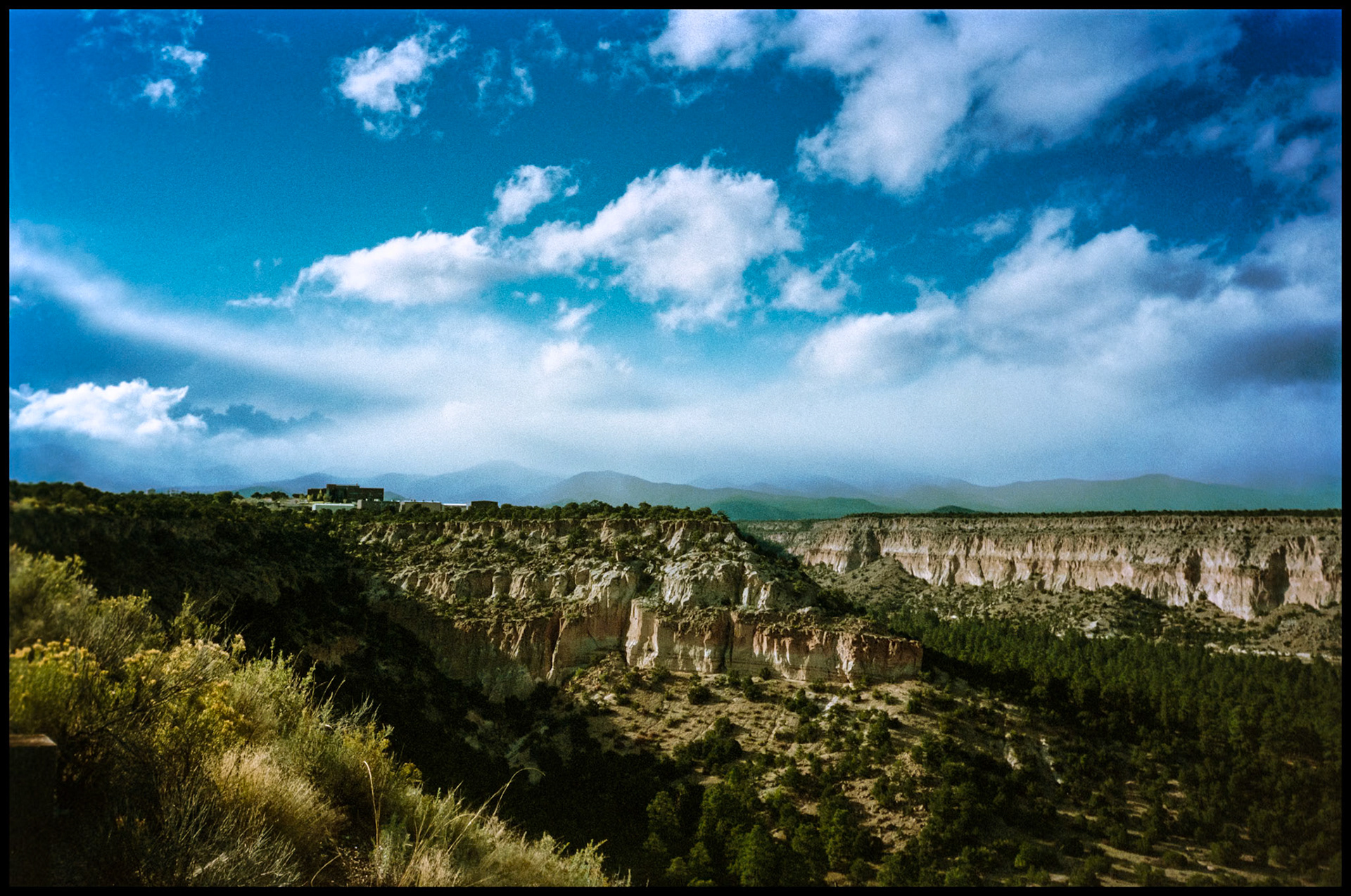 A vintage view of the cliifs at the East edge of Los Alamos from Highway 502. Los Alamos, New Mexico USA 1993