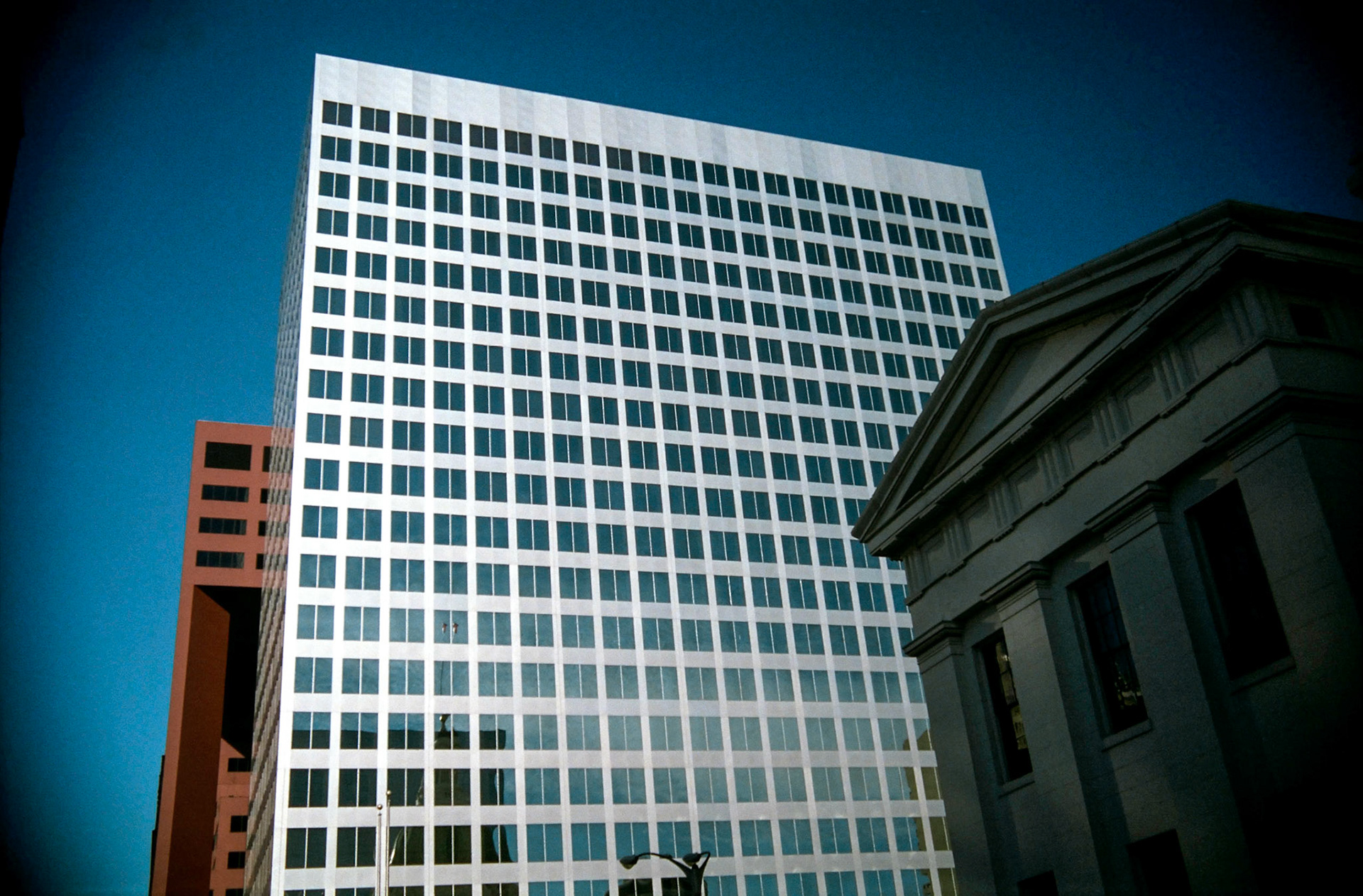 An office building looming over the Old Courthouse in downtown St. Louis, 1988. Part of a series shot one warm afternoon in November, 1988 called An Afternoon in St. Louis (a subset of my Industrial Geometry series).