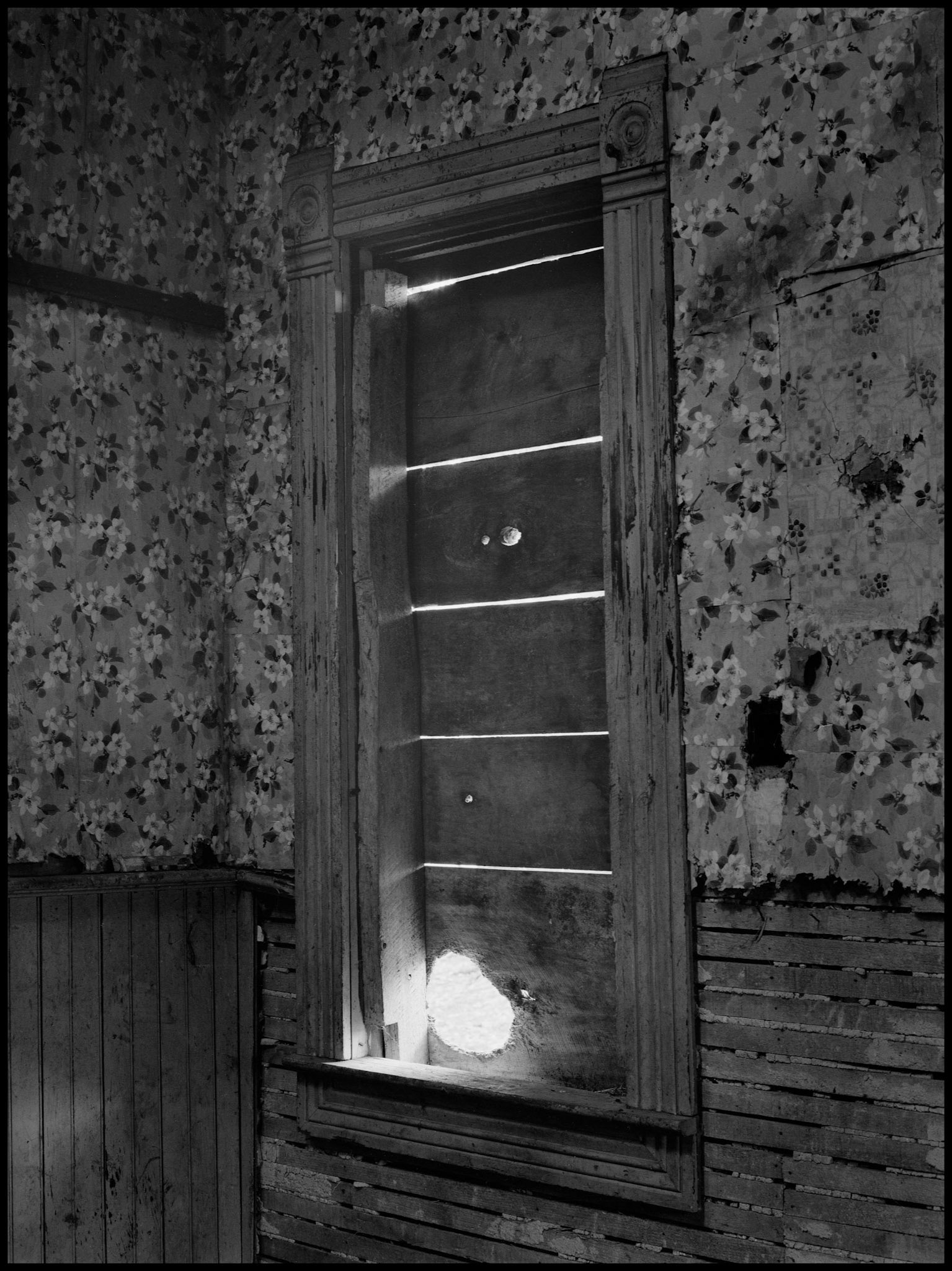 The interior of an abandoned house in an advanced state of decay. Near Pennville, Missouri USA, 1979.
