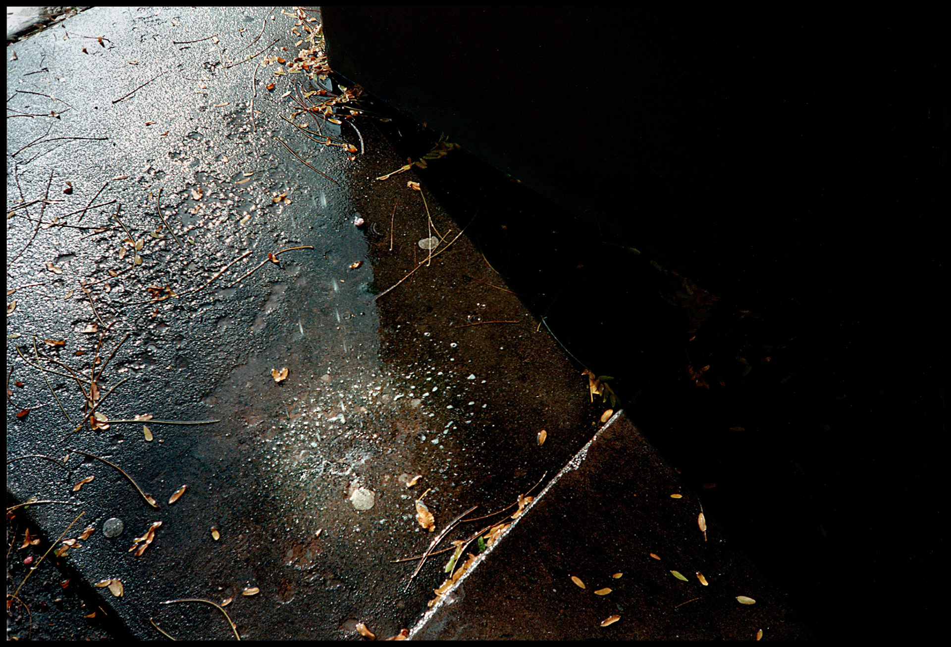 Yield and Overcome, Santa Fe, New Mexico,1993, Water dripping on Sidewalk in Santa Fe, NM showing the destructive power of pliable water over solid cement and illustrating a key principle of Taoism.