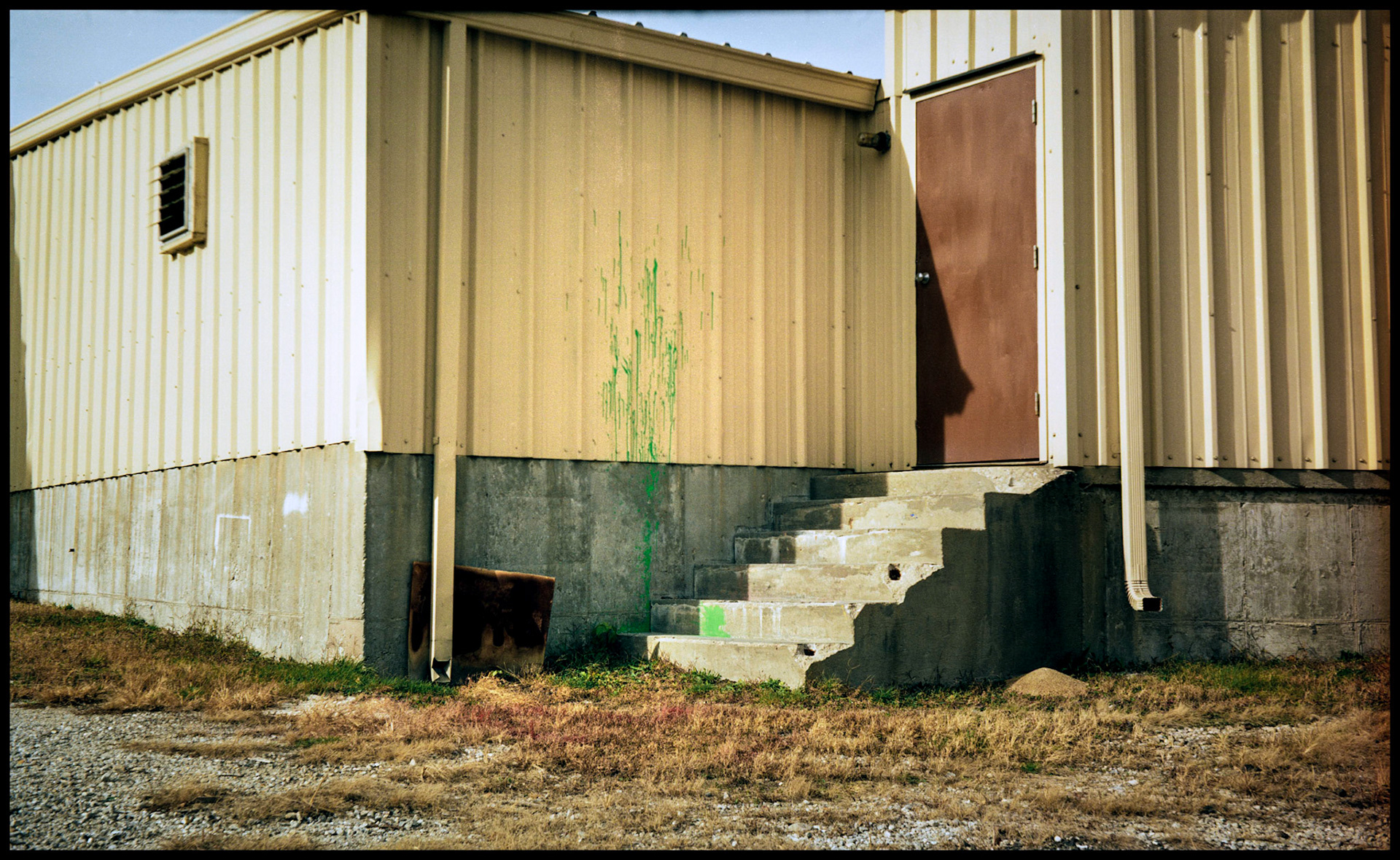 Green paint splattered on the wall outside the art department of Columbia College, Columbia, Missouri 1989
