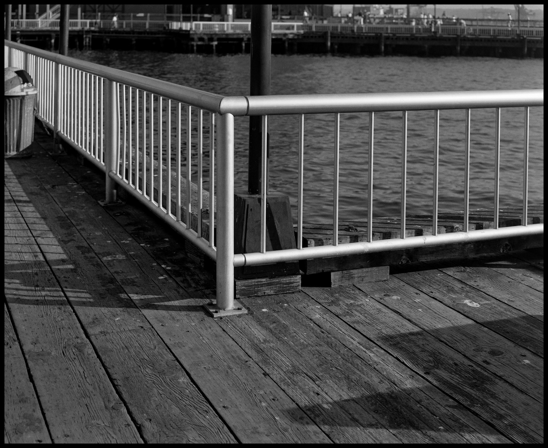 A vintage black and white image of a metal handrail on a Seattle waterfront pier. Seattle Washington USA 1987