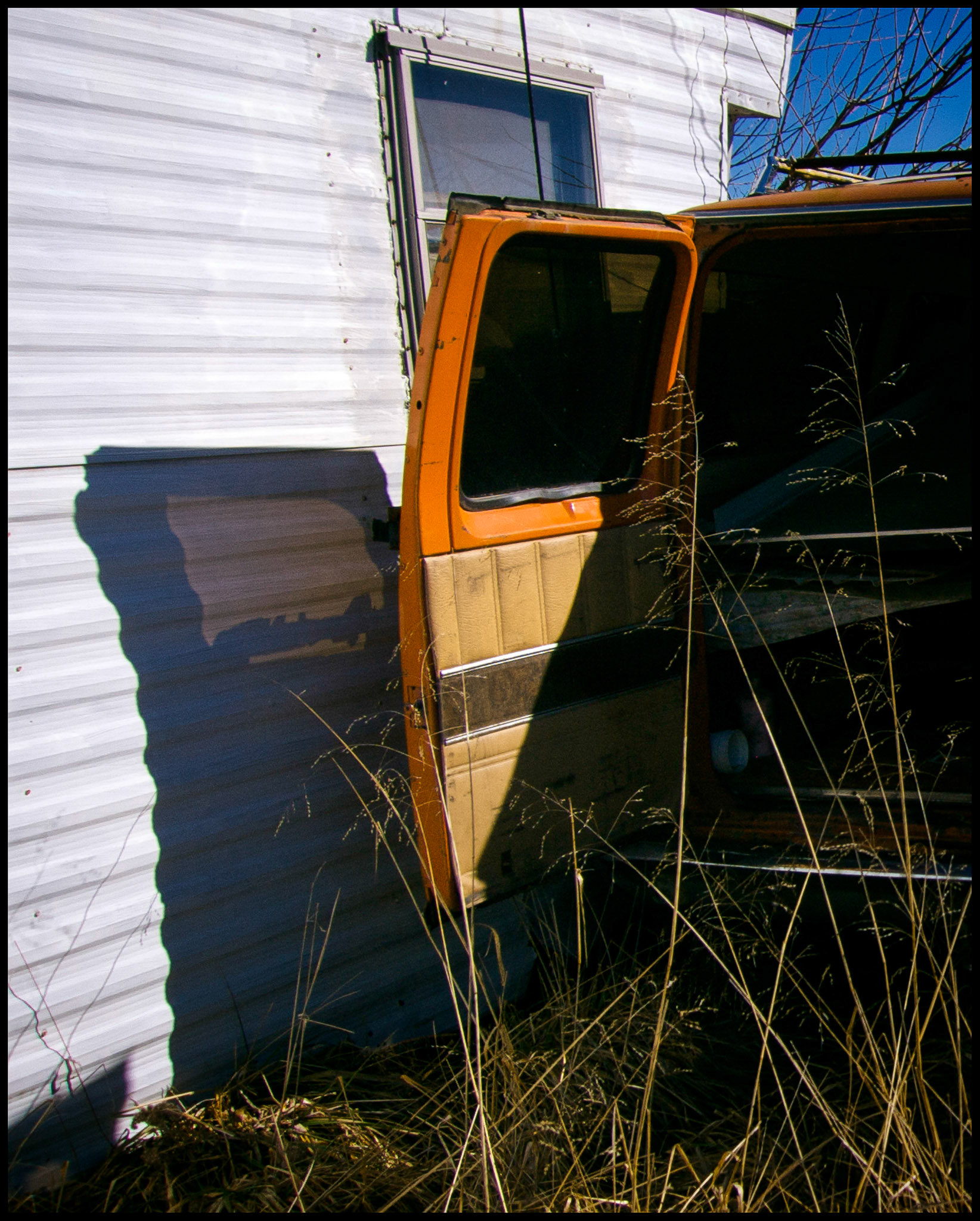 A minimal abstract "parting" shot of the back door and shadow of my trusty old steed 1976 Ford E-150 Club Wagon van before sending it off to the salvage yard. Near Renick, Missouri 2007