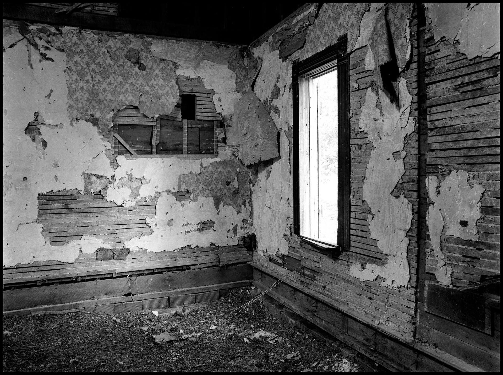 The interior of an abandoned house in an advanced state of decay. Near Pennville, Missouri USA, 1979.
