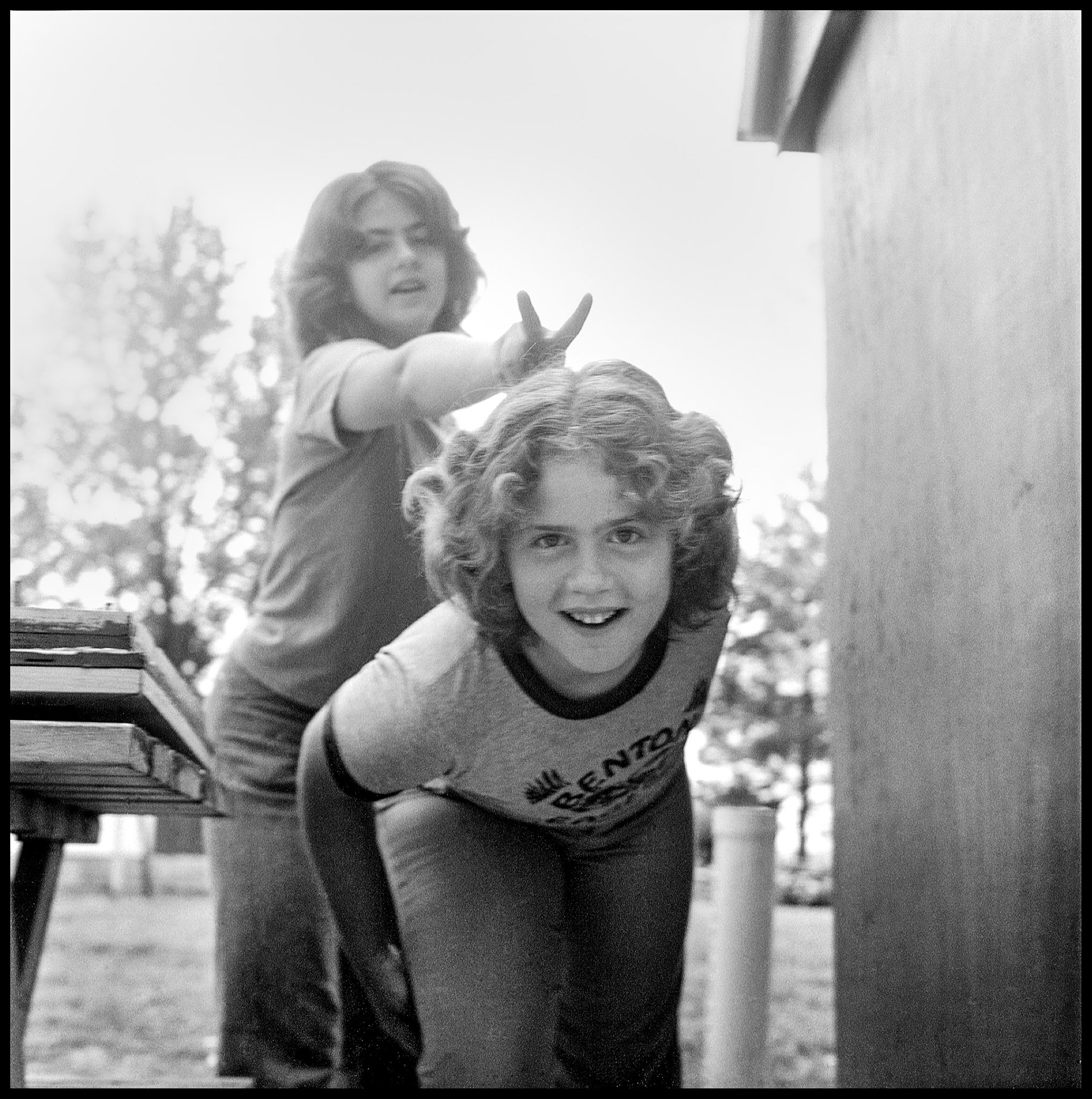 Two teenage sisters being silly for the camera. Kirksville, Missouri 1978
