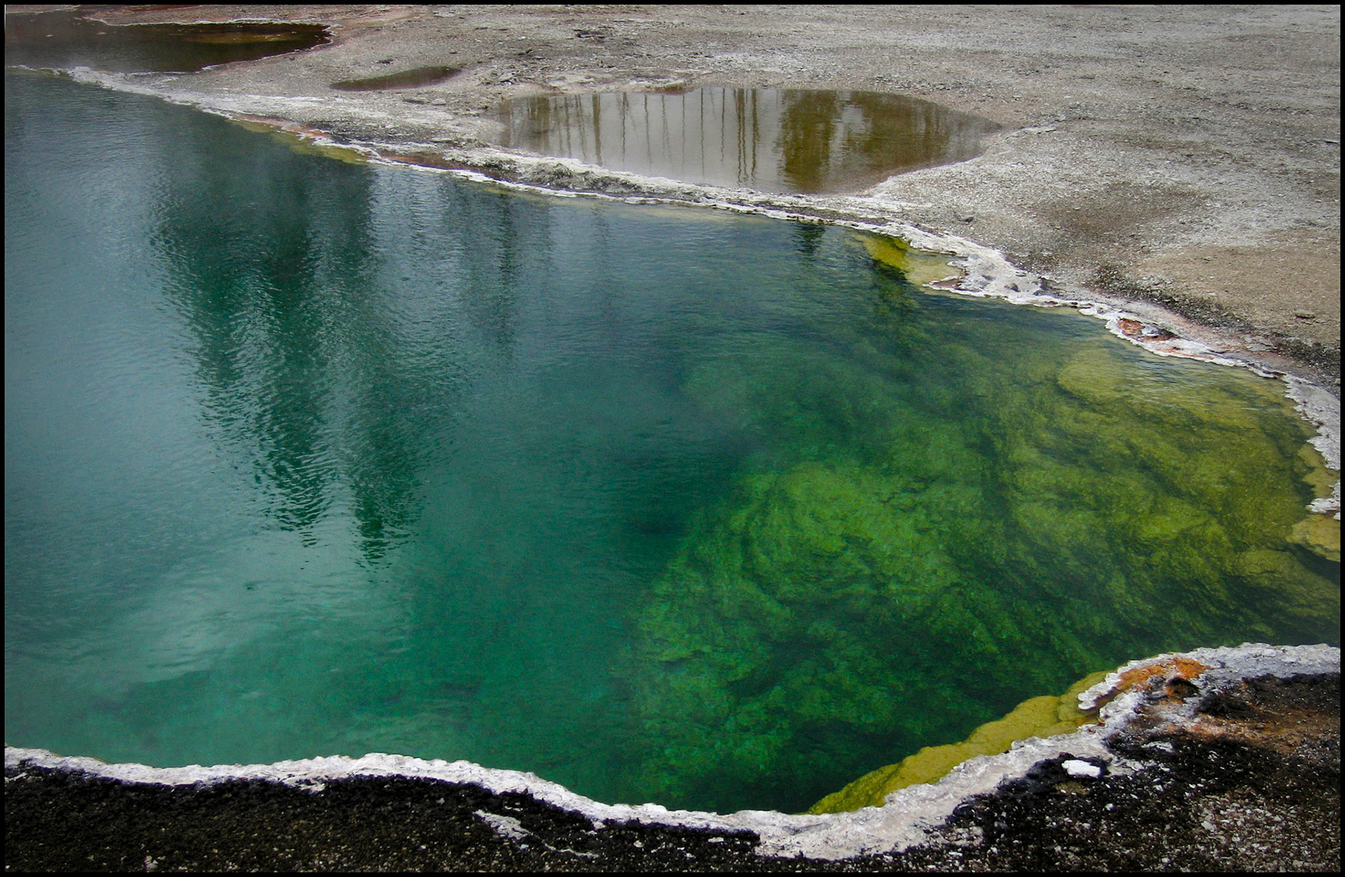 An abstract minimal detail view of the colorful deep waters of the Abyss Pool at West Thumb Geyser Basin in Yellowstone National Park, Wyoming, USA, 2005