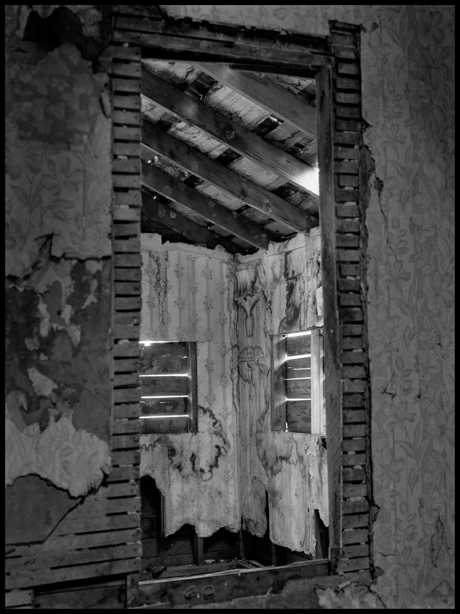 The interior of an abandoned house in an advanced state of decay. Near Pennville, Missouri USA, 1979.