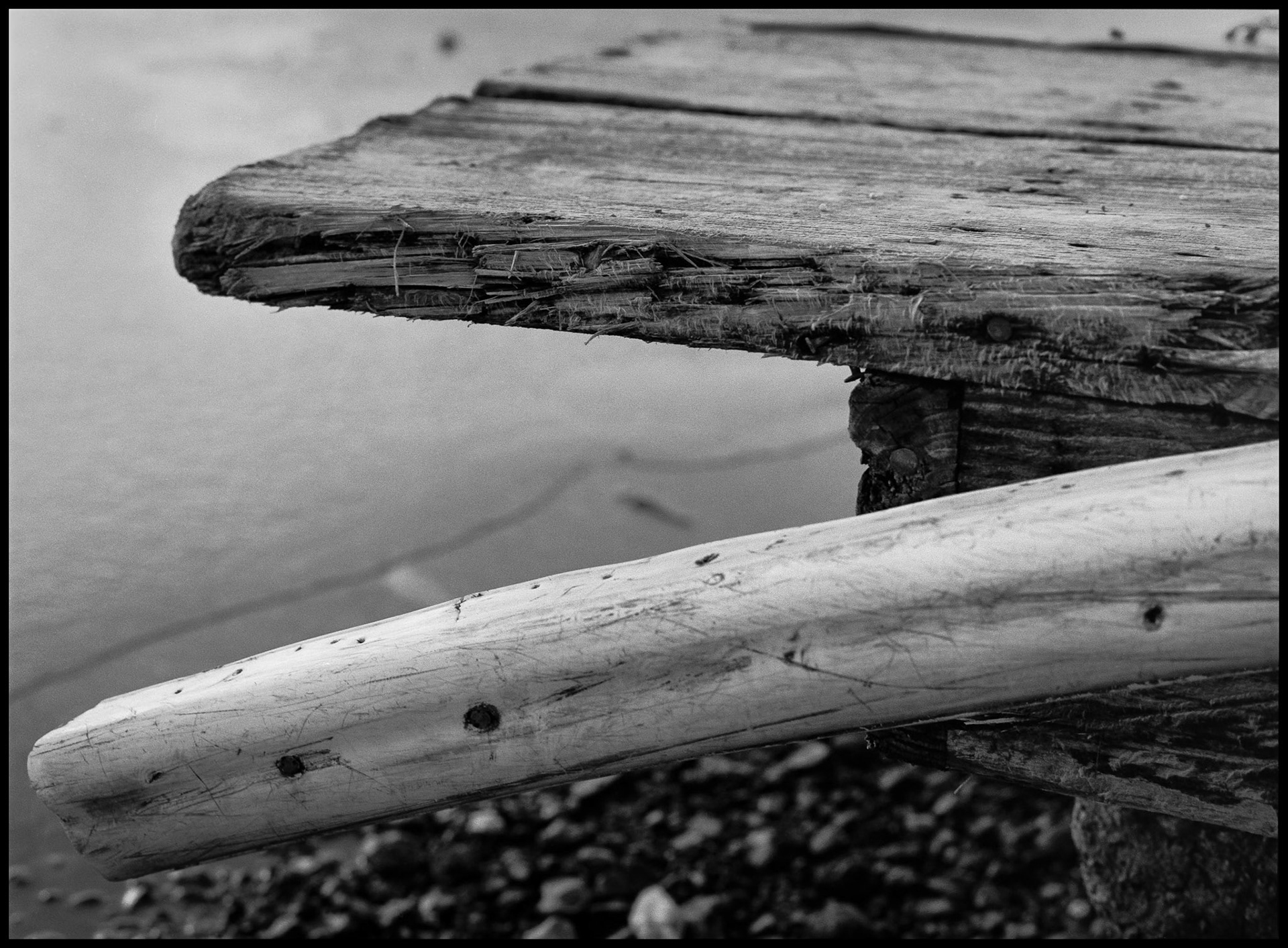 A minimal abstract view of a warped and rotting dock at the edge of a lake for winter. Thousand Hills State Park, Kirksville, Missouri 1980