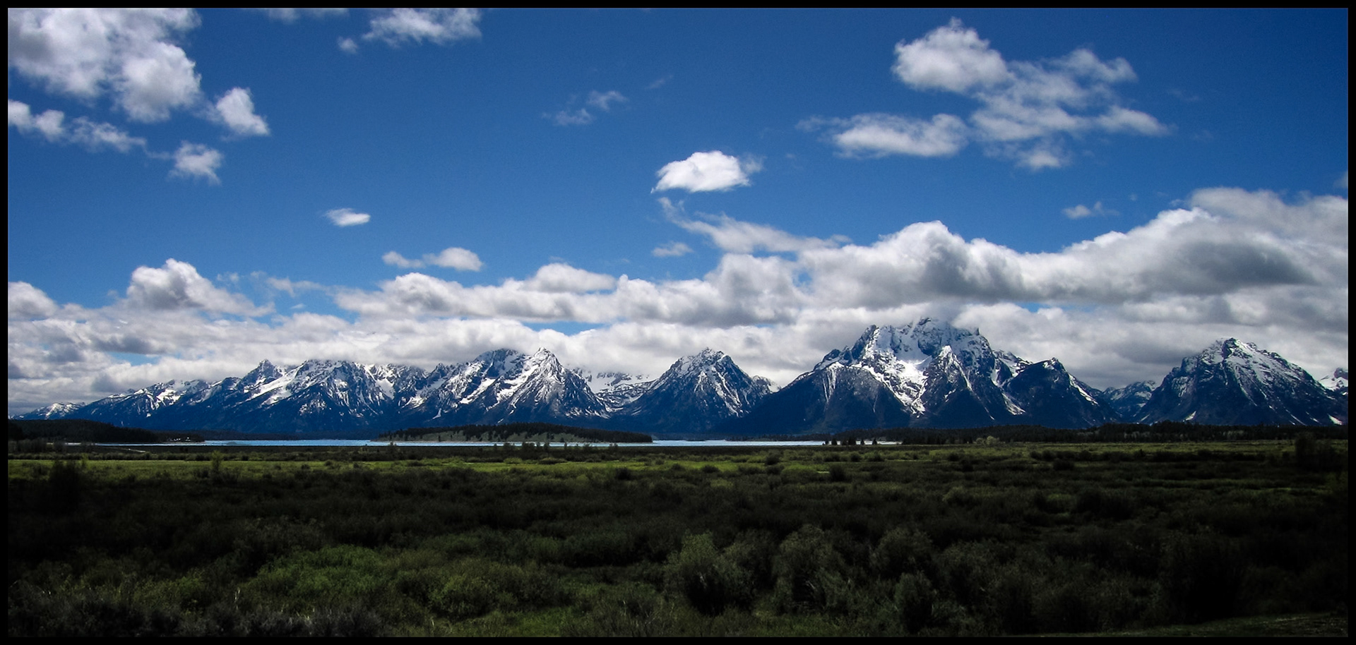 Panoramic view of the Teton mountain range with the peaks obscured by low clouds taken from Grand Teton National Park near Jackson Hole, Wyoming USA 2005.