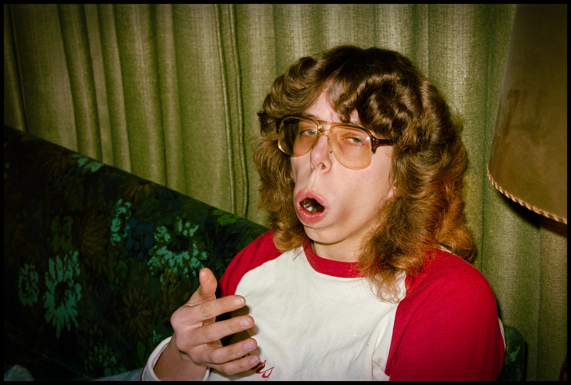 A whimsical image of a woman caught in a funny moment just after putting an entire mini-doughnut in her nouth. Kirksville Missouri, 1984