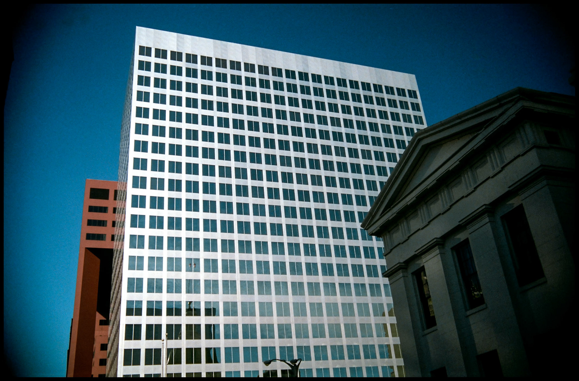 An office building looming over the Old Courthouse in downtown St. Louis, 1988. Part of a series shot one warm afternoon in November, 1988 called An Afternoon in St. Louis (a subset of my Industrial Geometry series).