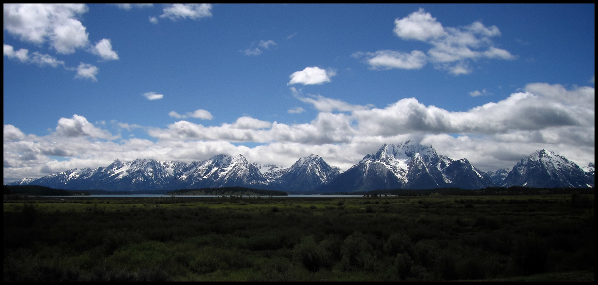 Panoramic view of the Teton mountain range with the peaks obscured by low clouds taken from Grand Teton National Park near Jackson Hole, Wyoming USA 2005.