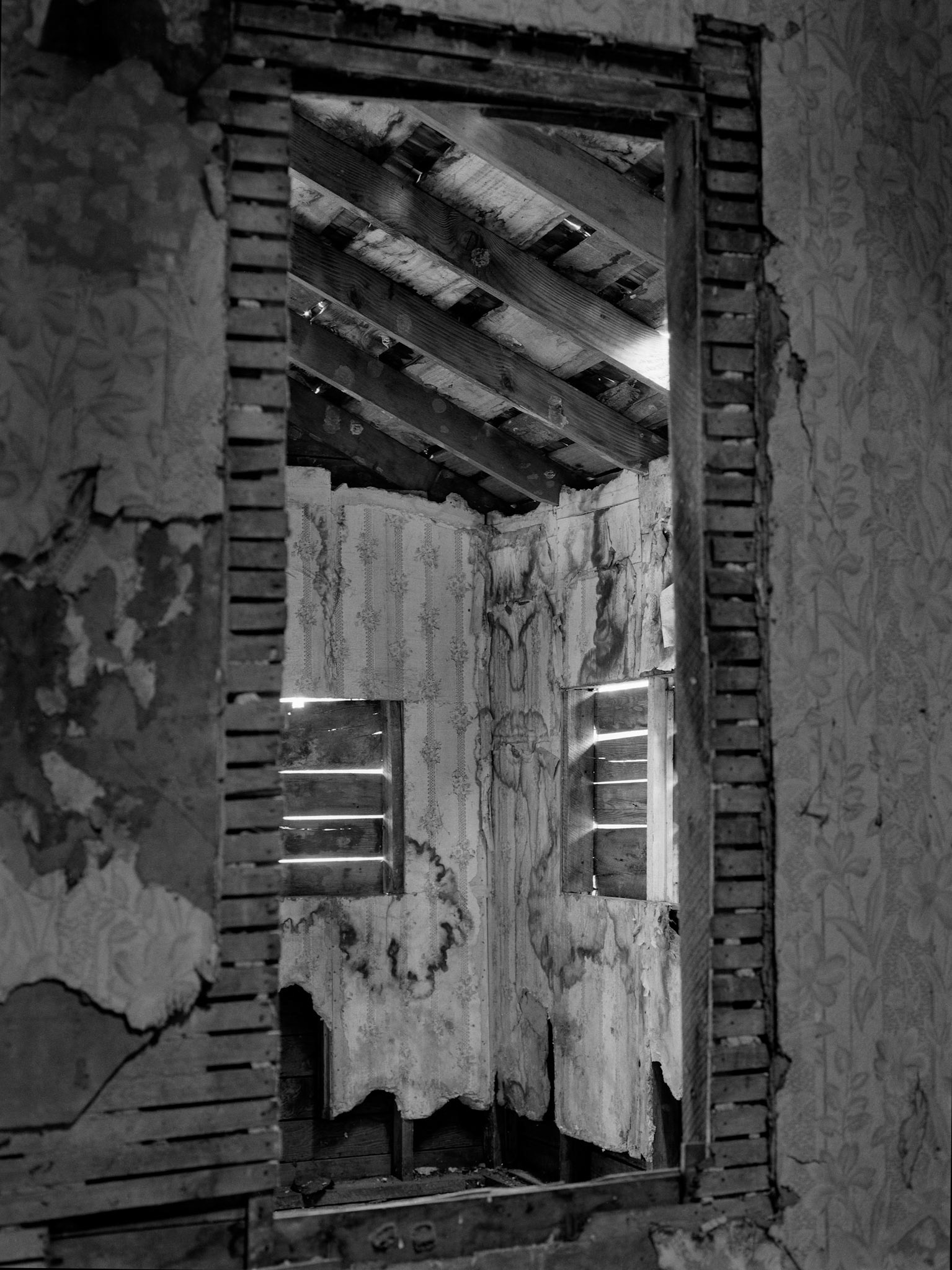 The interior of an abandoned house in an advanced state of decay. Near Pennville, Missouri USA, 1979.