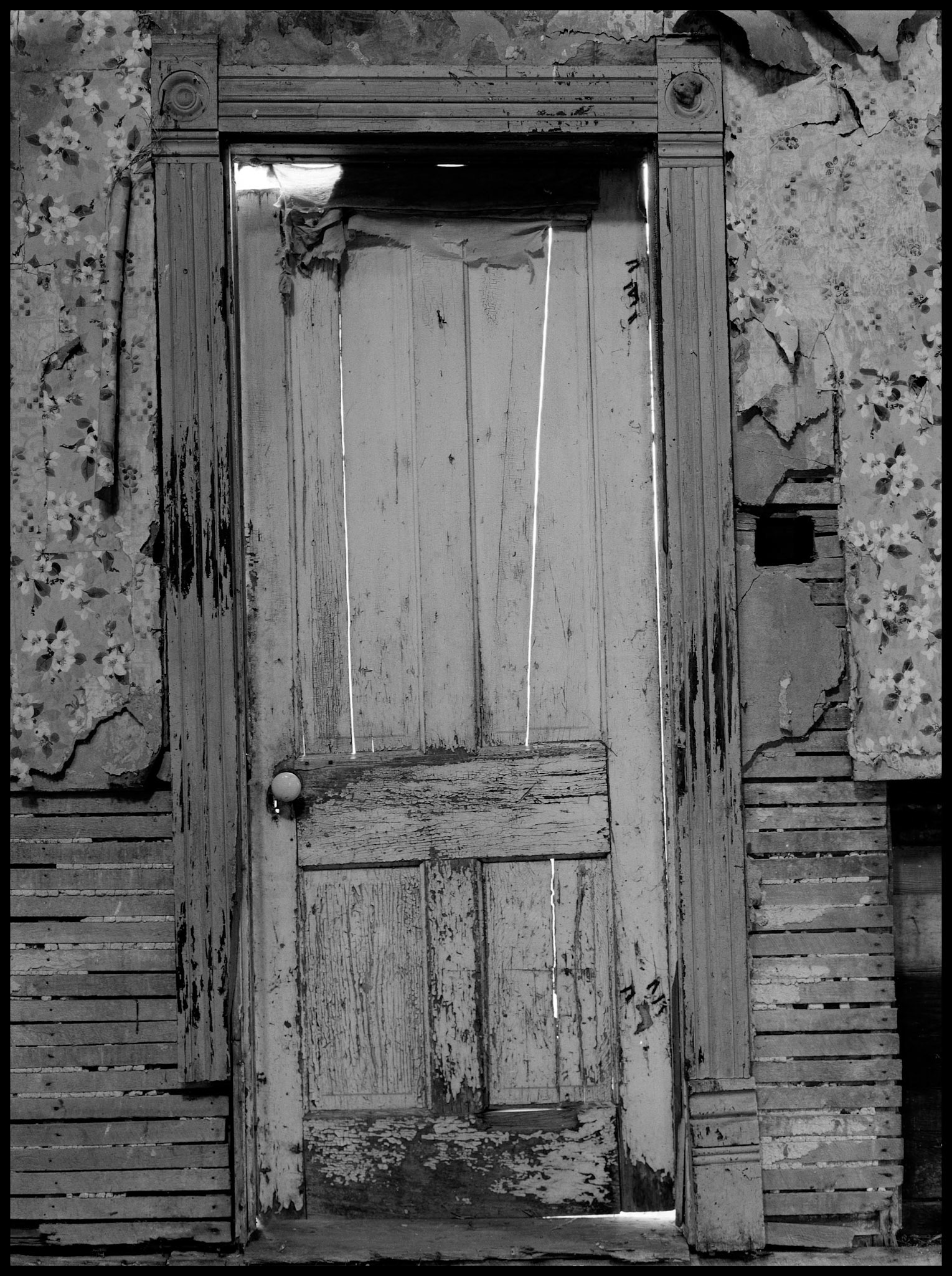 The interior of an abandoned house in an advanced state of decay. Near Pennville, Missouri USA, 1979.