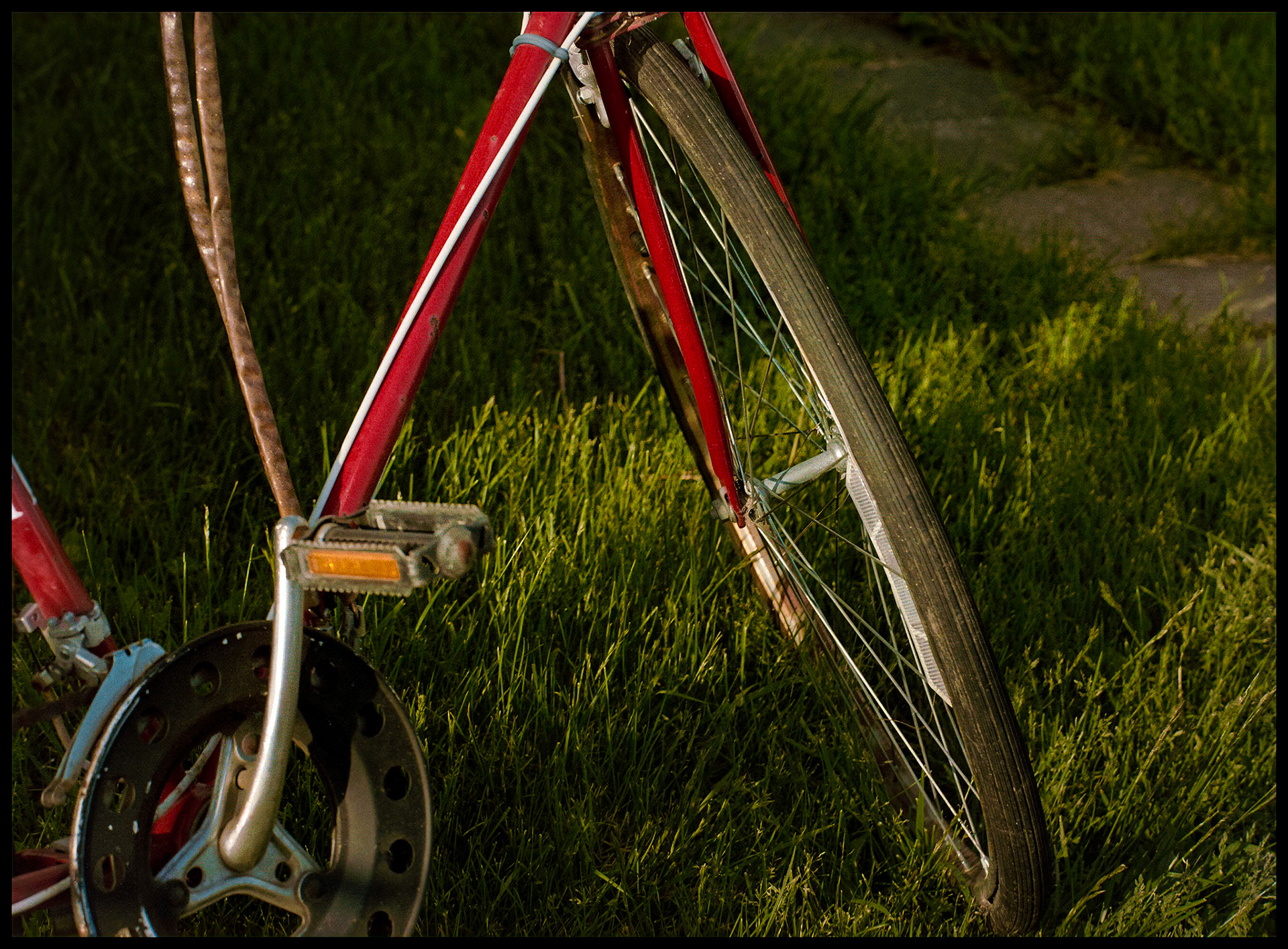 A minimal abstract view of the lines of a bicycle leading to the hub of the front wheel. Kirksville, Missouri 1983
