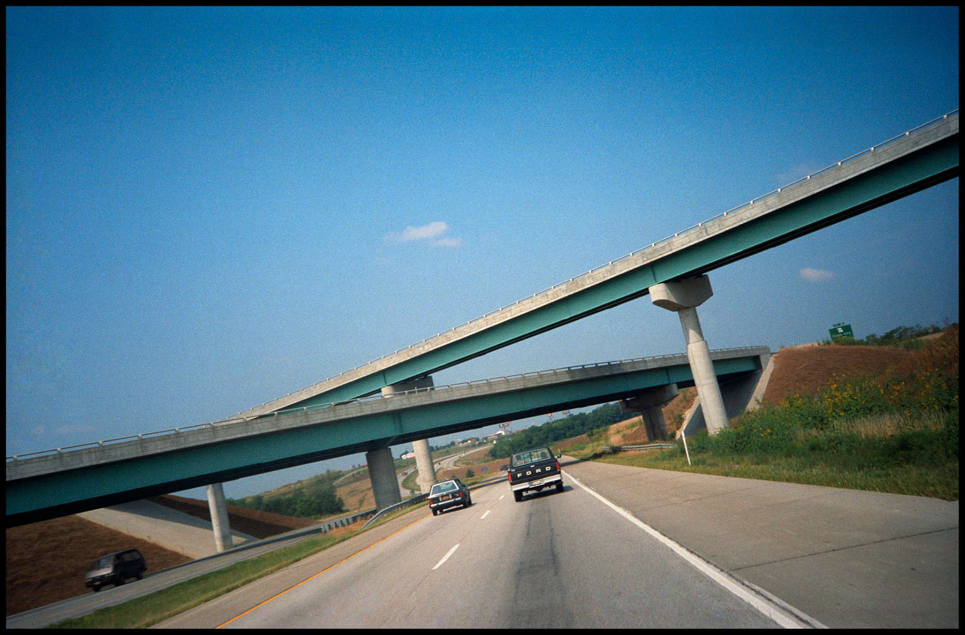 Two cars approaching overpasses on I-29, near Kansas City, Missouri 1991
