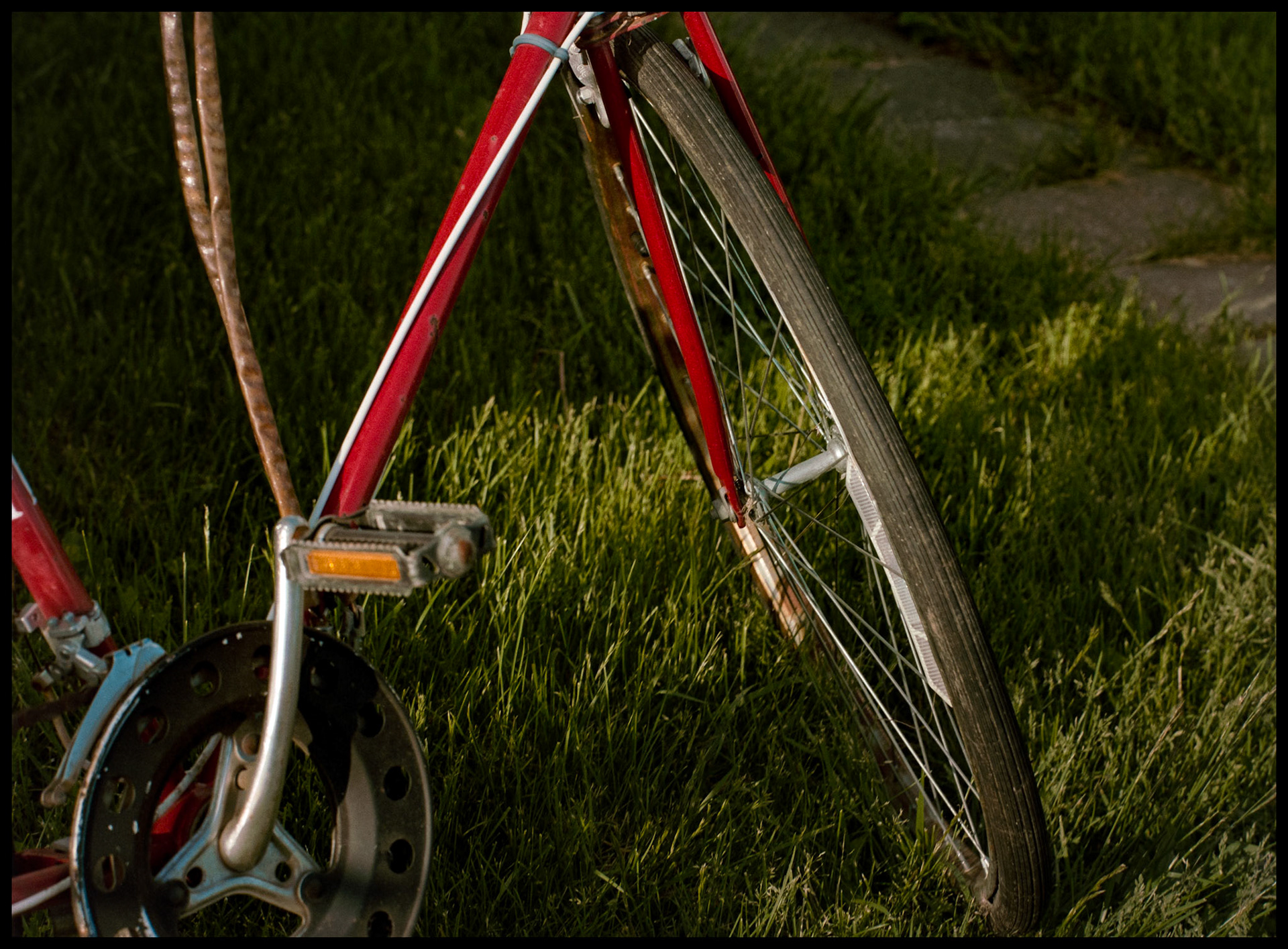 A minimal abstract view of the lines of a bicycle leading to the hub of the front wheel. Kirksville, Missouri 1983