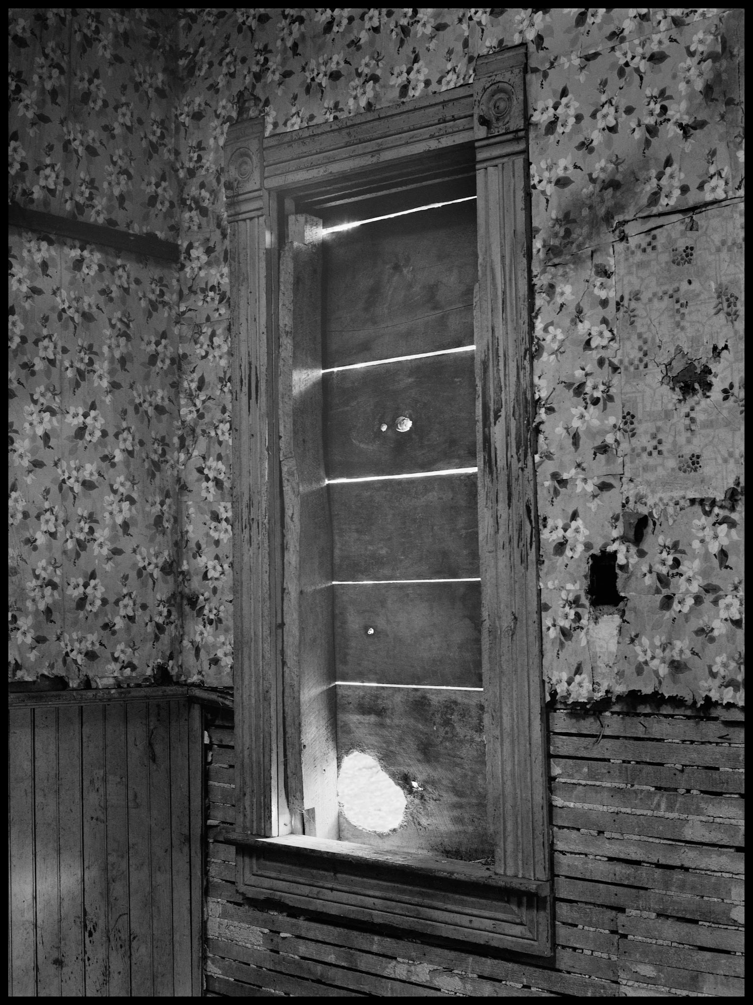 The interior of an abandoned house in an advanced state of decay. Near Pennville, Missouri USA, 1979.