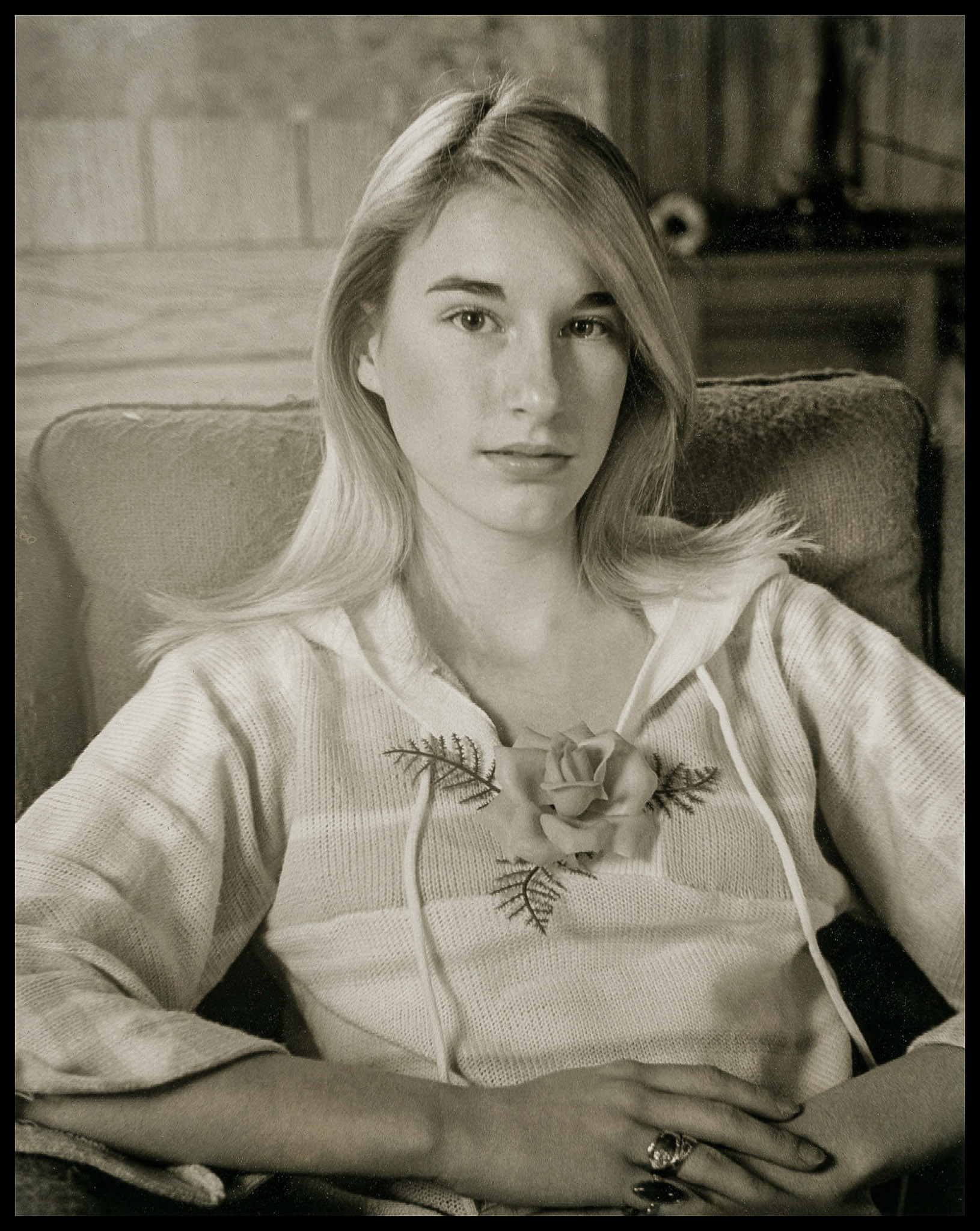 A young woman sitting in a chair with an intent gaze. Green City, Missouri 1977
