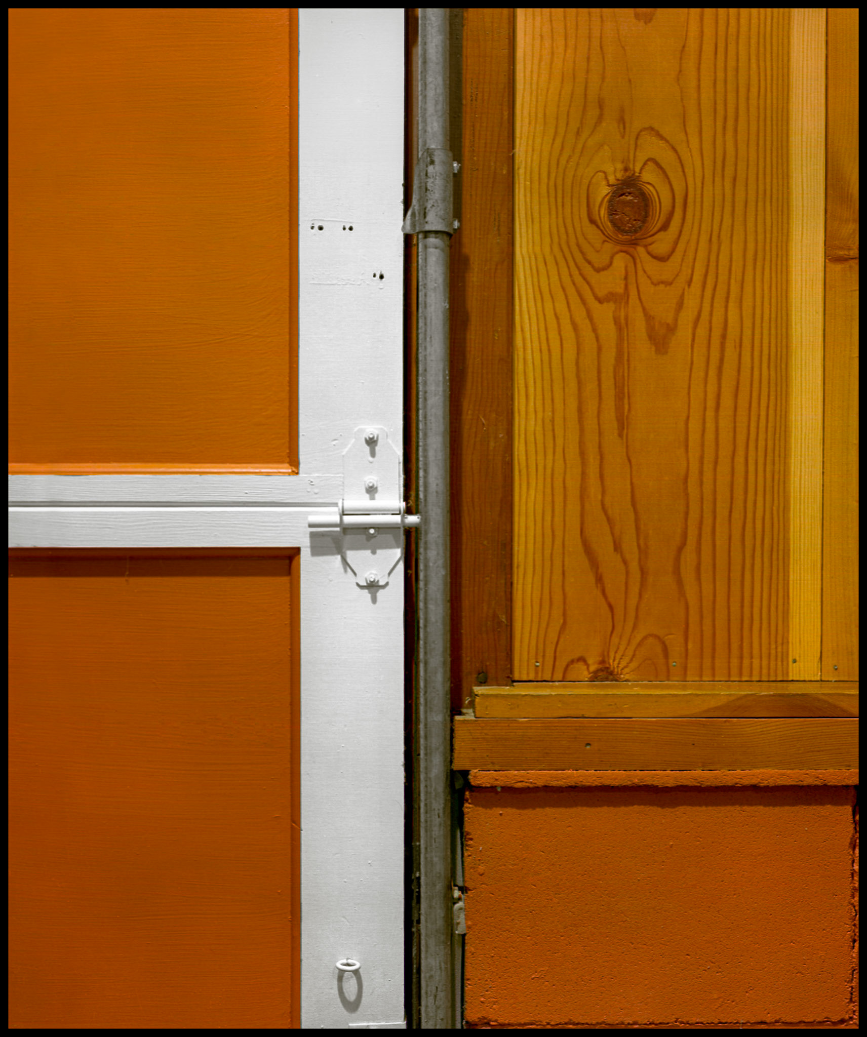 An abstract minimalist detail of the garage door, rail, brick foundation, and wooden panel in my family home next to my darkroom in the 1970s. An homage to Piet Mondrian.