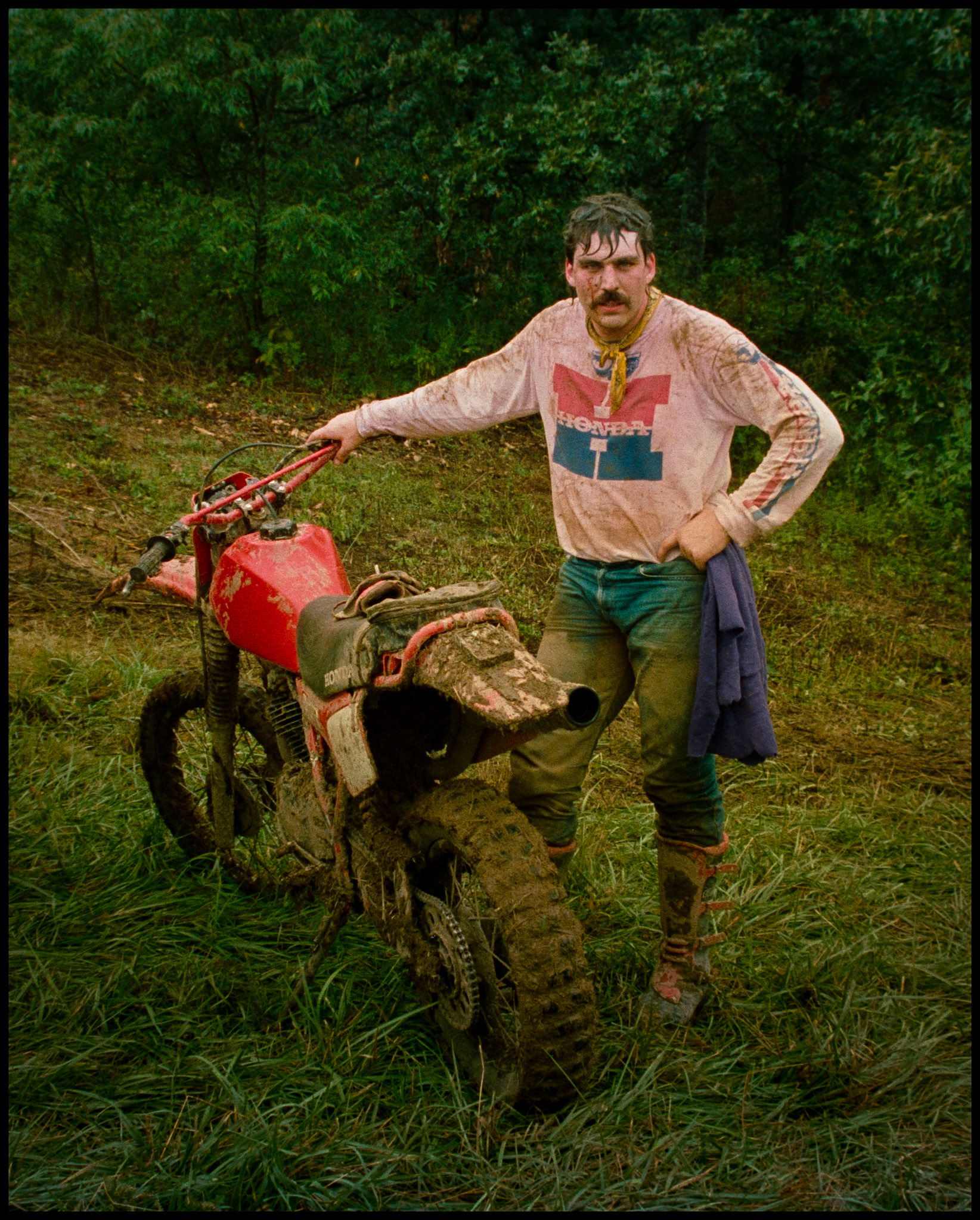 A young man next to his dirt bike after a long race. Near Bixby, Missouri 1986