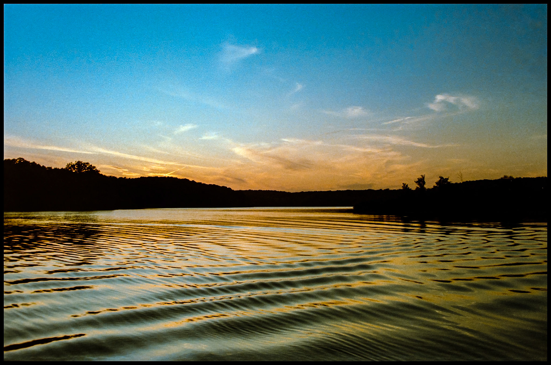 Pastel dusk sky reflections on water ripples in a lake. Forest Lake, Thousand Hills State Park, Kirksville, Missouri 1984