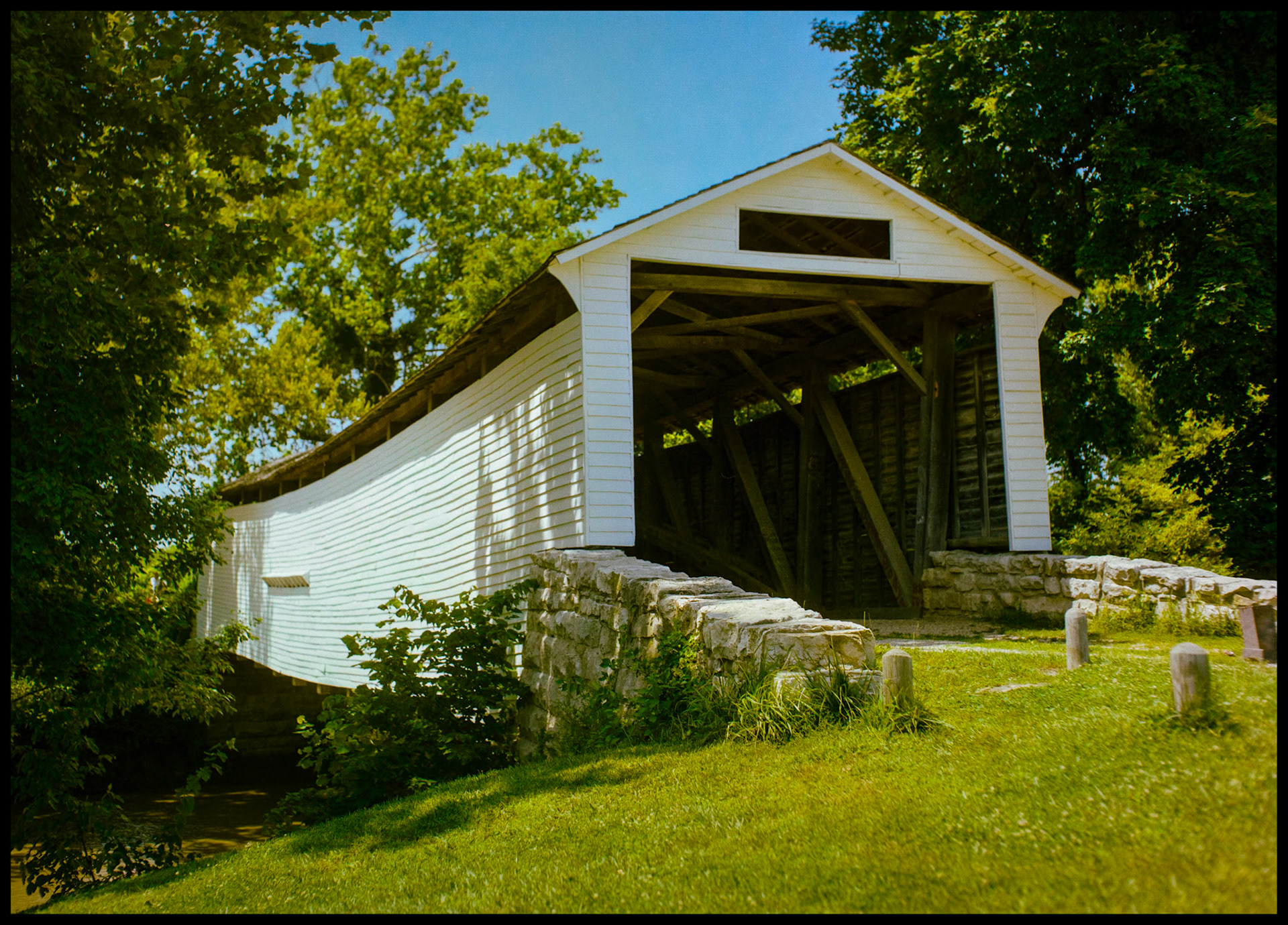 A 1984 vintage image of the Union Covered Bridge at the Union Covered Bridge State Historical Site near Paris, Missouri. The Union Covered Bridge, built in 1871, spans the Elk Fork of the Salt River in Monroe County Missouri and is the only one of the four remaining covered bridges in Missouri that represents the Burr-arch truss design. It served travelers in Monroe County for 99 years.