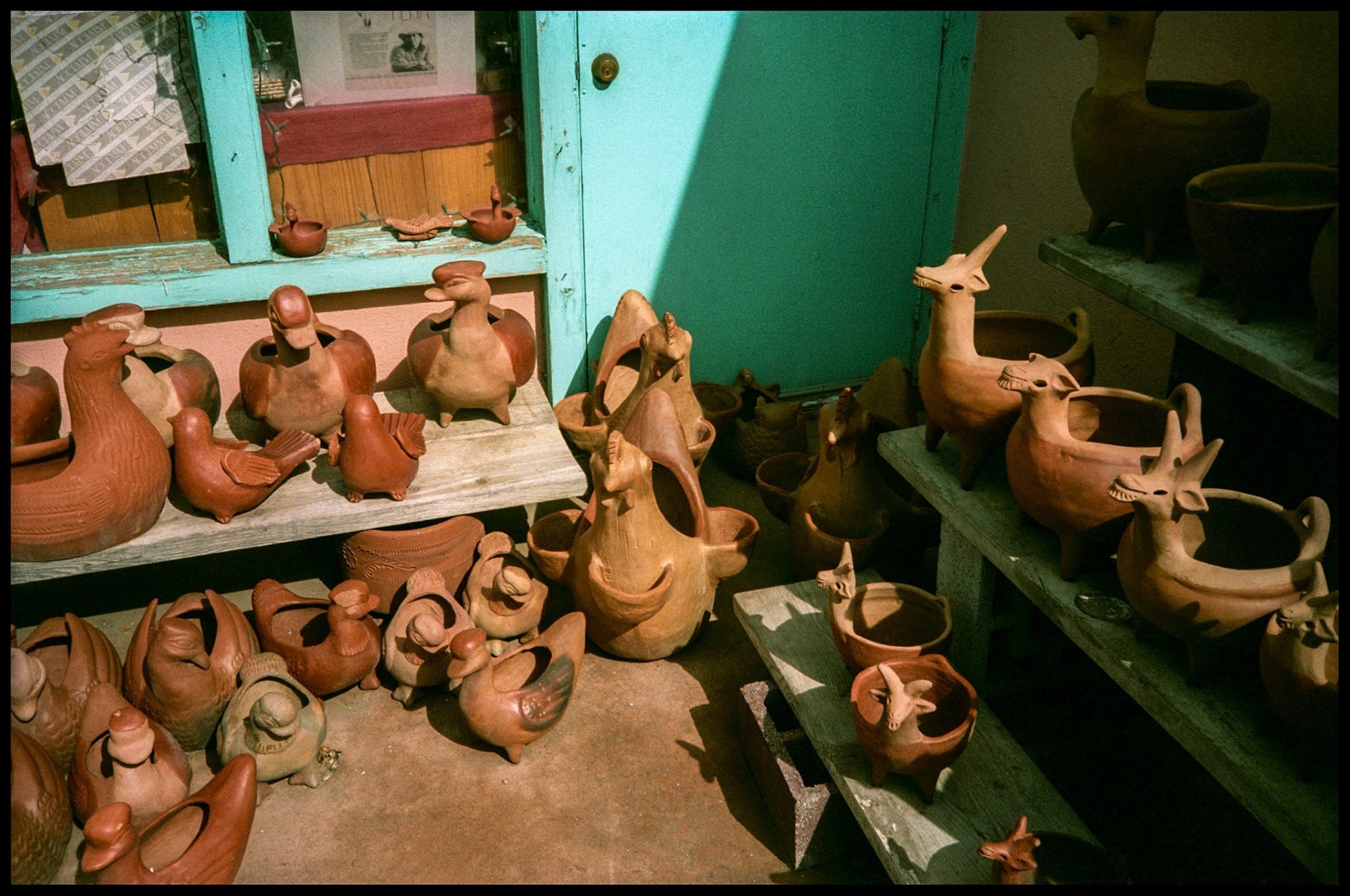 A vintage image of a group of whimsical clay pottery animal planters and figurines in a public market in downtown Santa Fe, New Mexico USA 1993