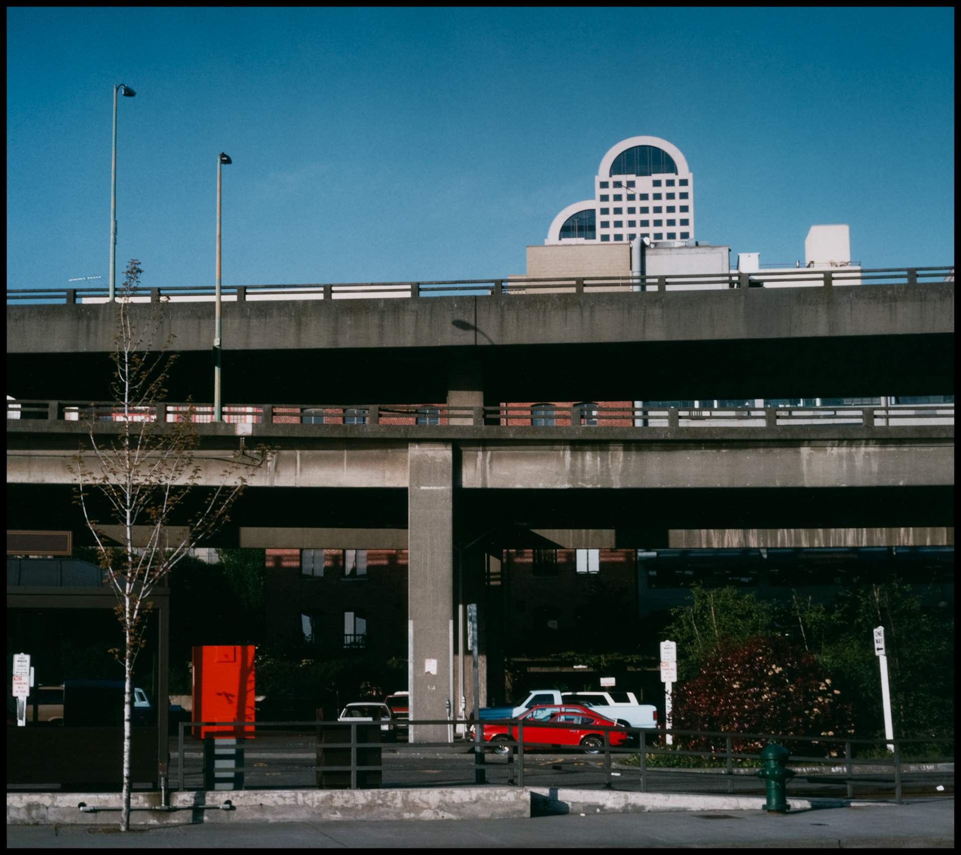 Vintage view of raised highway and Seattle skyline from Alaska Way near the waterfront. Seattle Washington USA 1987