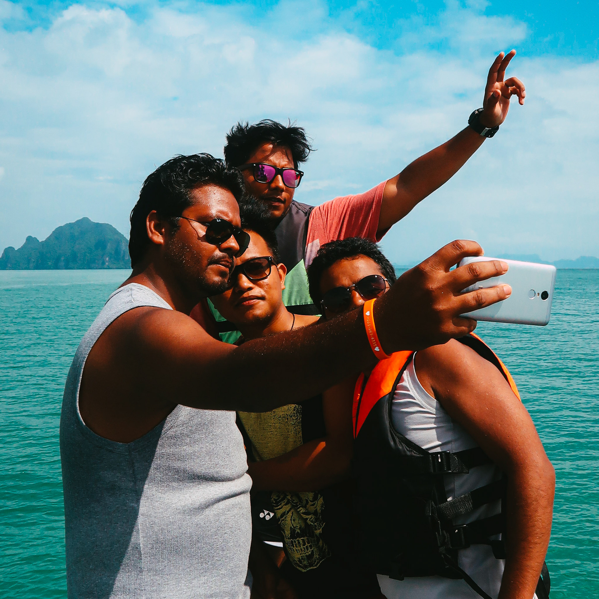 A group of Indian men take a selfie on a boat – Ao Phang Nga National Park, Thailand