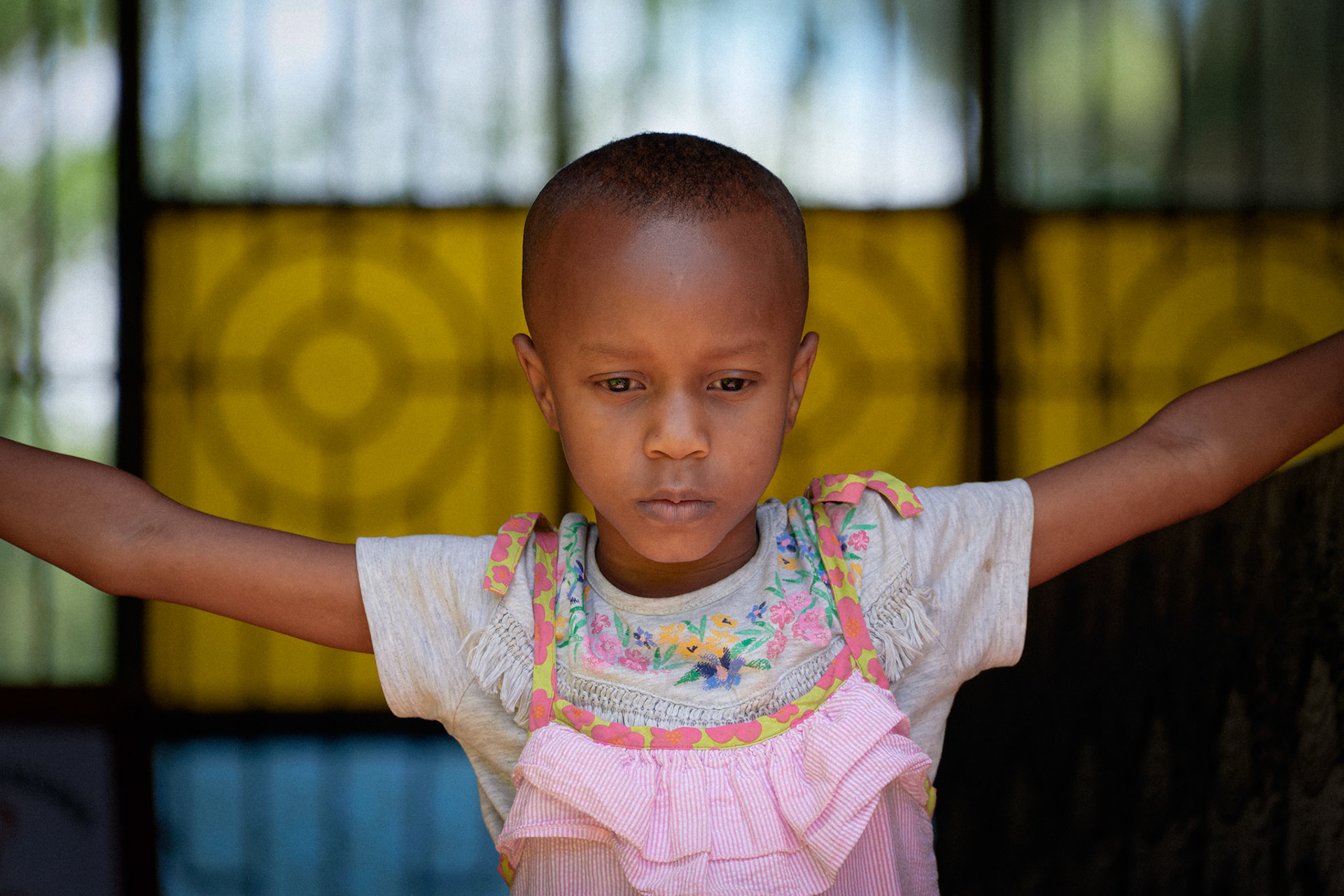 A young girl standing in the doorway of the library – Mwika Village, Kilimanjaro Region, Tanzania