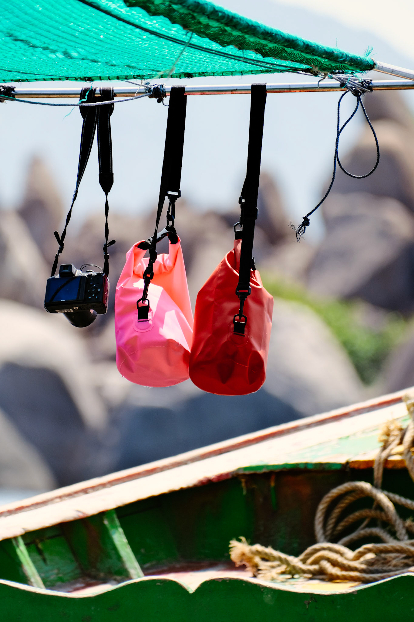 A general view of a camera and dry bags hanging on a boat – Nangyuan Island Beach, Ko Tao, Thailand
