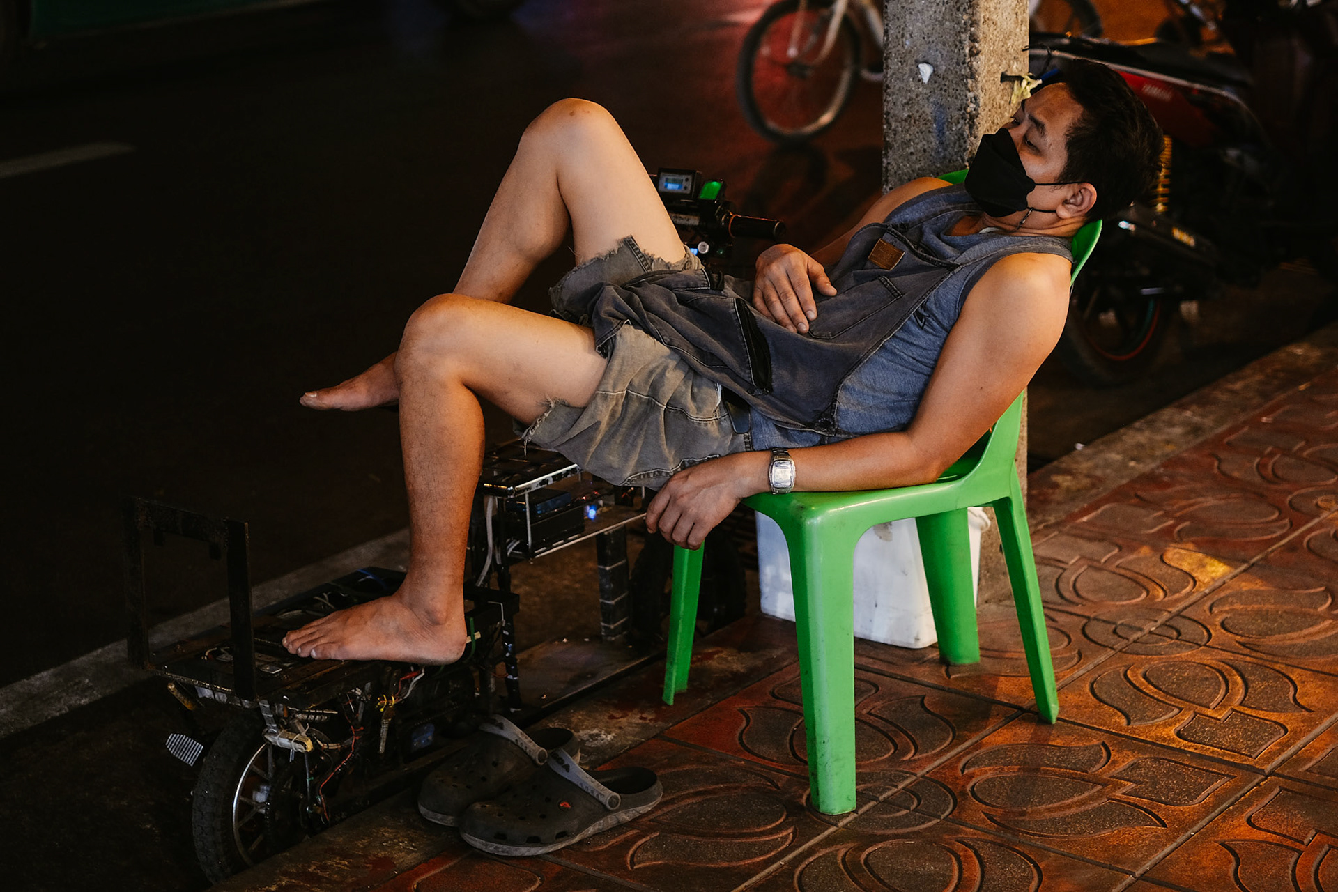 A man sleeps outside his shop – Bangkok, Thailand