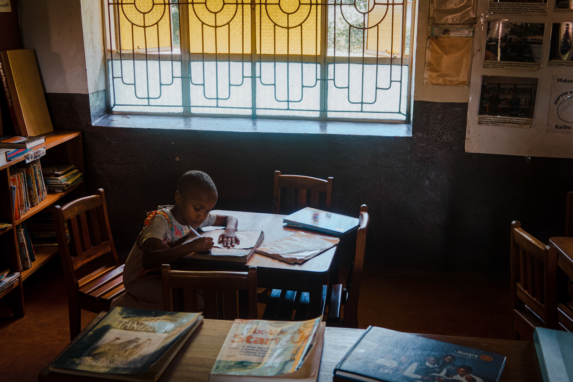 A young girl studies in the library – Mwika Village, Kilimanjaro Region, Tanzania