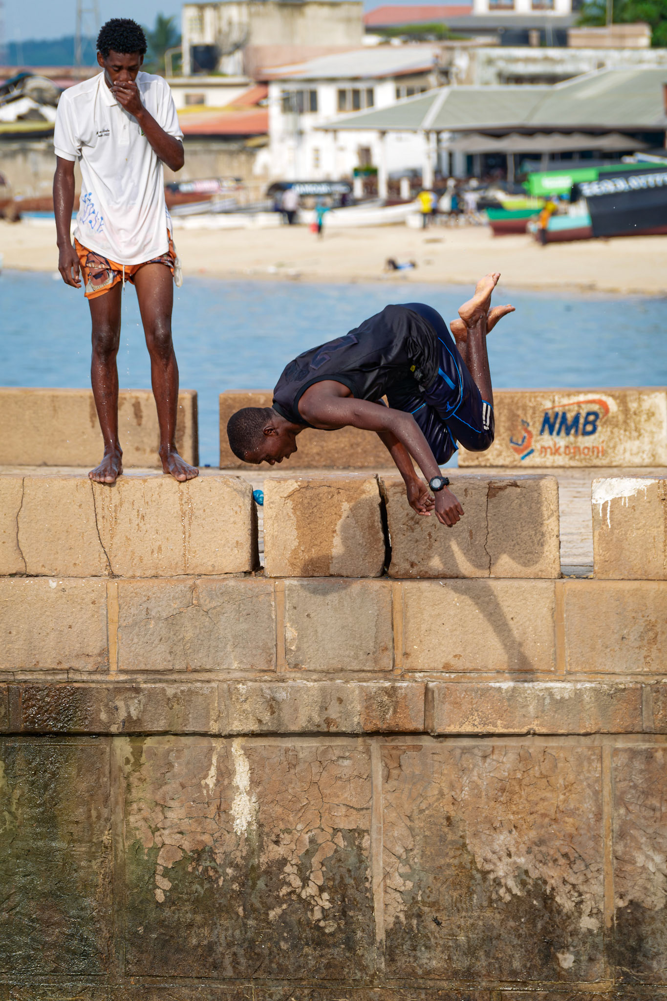 Young men jump off the pier – Stone Town, Zanzibar, Tanzania