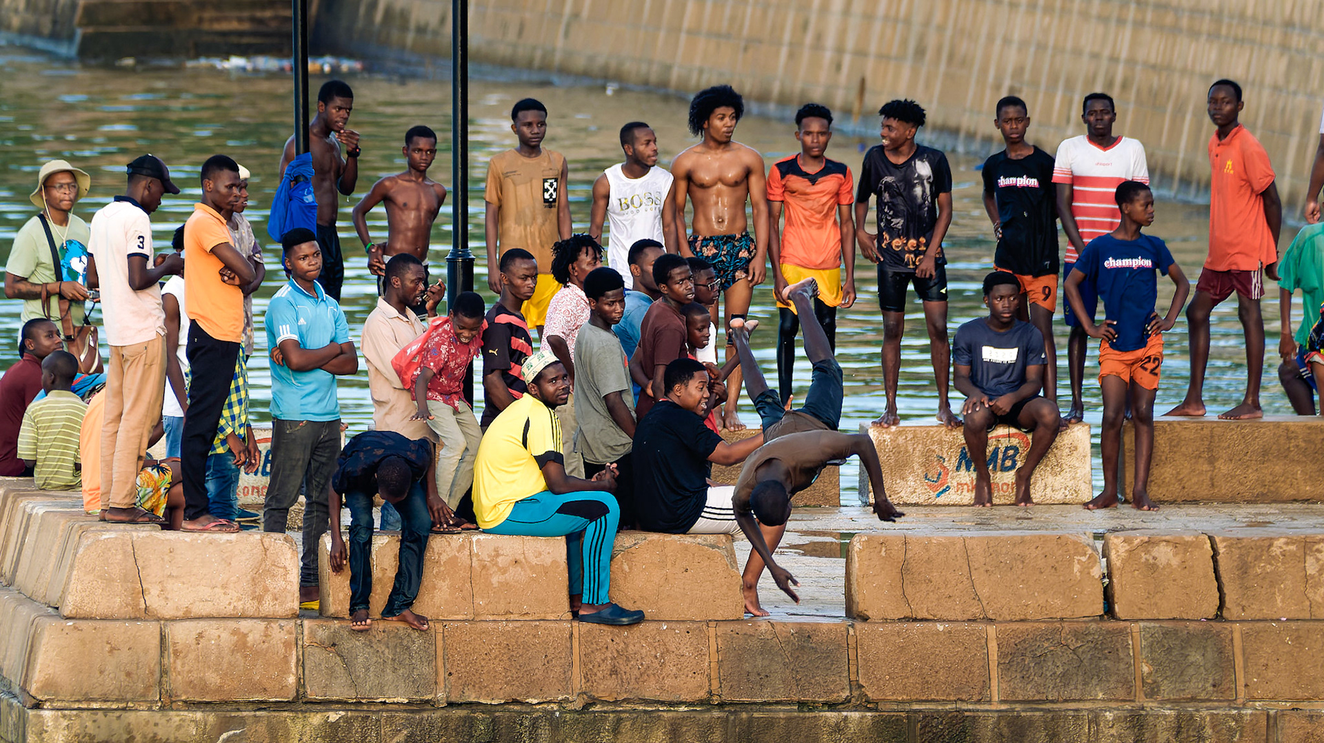 Young men jump off the pier – Stone Town, Zanzibar, Tanzania