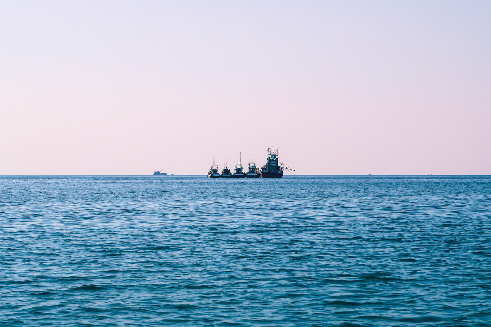 Four fishing boats lined up on the sea – Koh Rong Sanloem, Sihanoukville, Cambodia