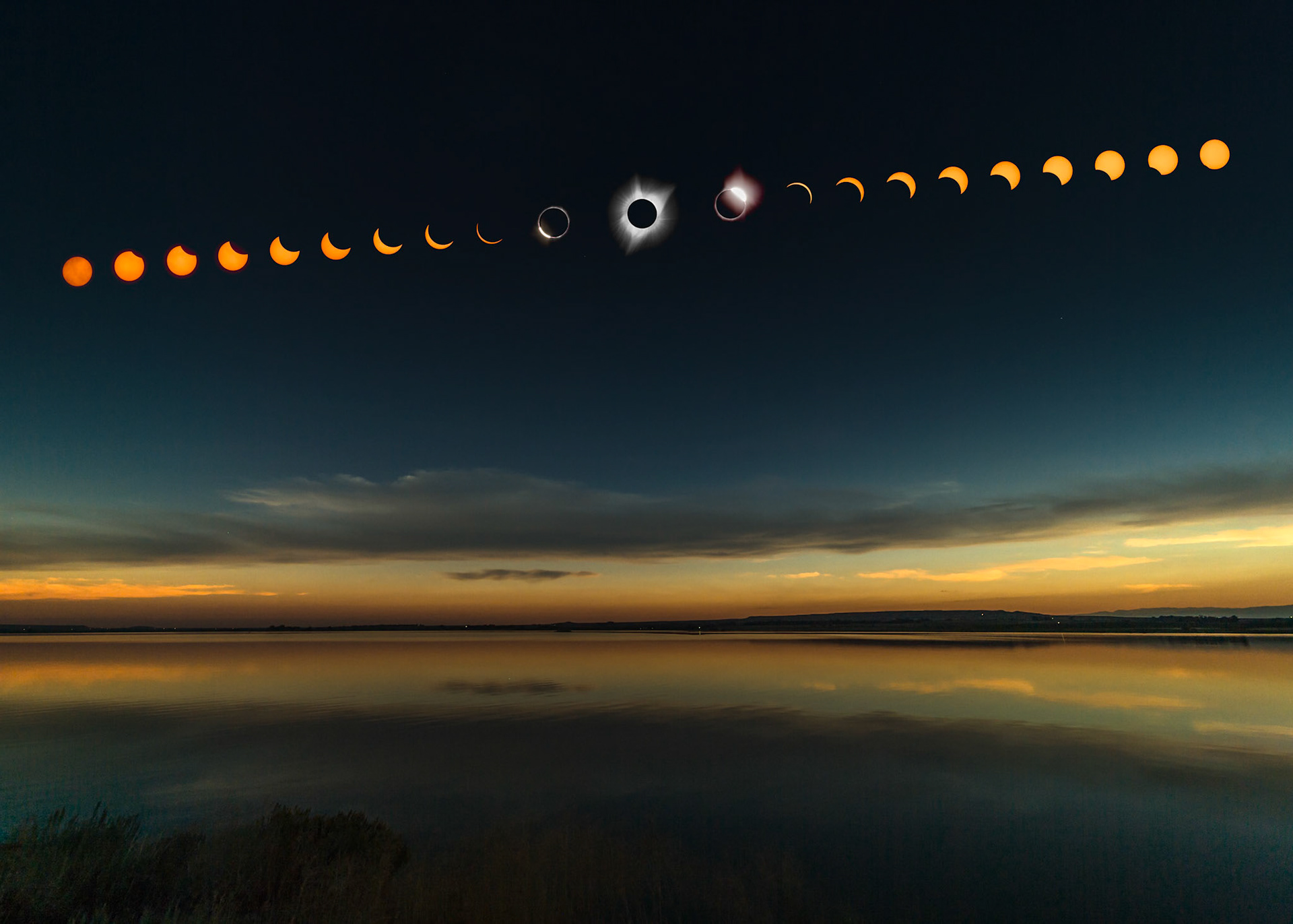 During the 2017 full solar eclipse, outside the sun's shadow, 12 miles away, the clouds and landscape turn orange, as it would during a sunset. That is the half shadow, the area where only a partially eclipsed sun illuminates the landscape.