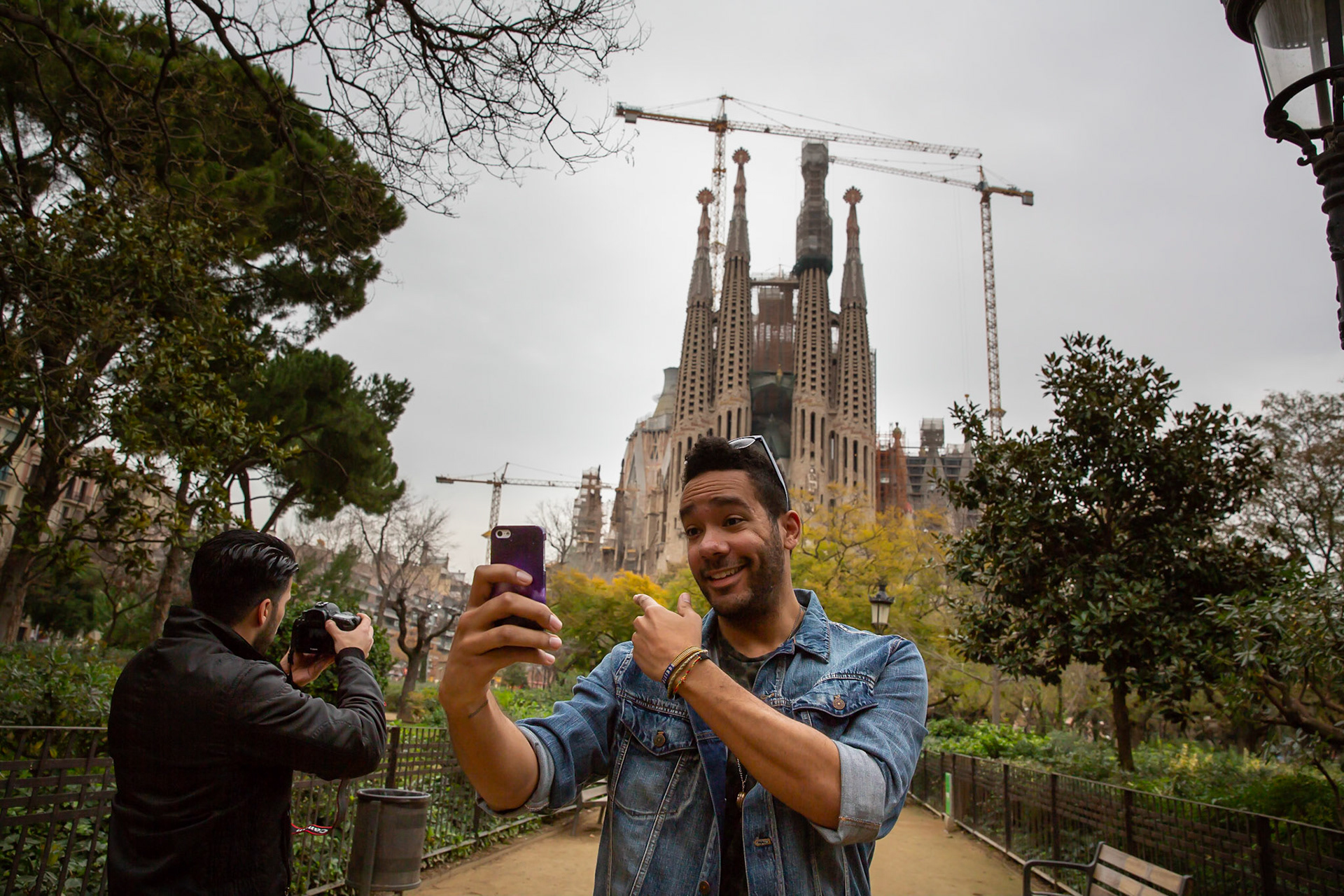 Barcelona, Spain, 20.02.2014: Chris is taking a selfie in front of La Sagrada Famiglia in Barcelona for the social-media-streams of The Exchange.