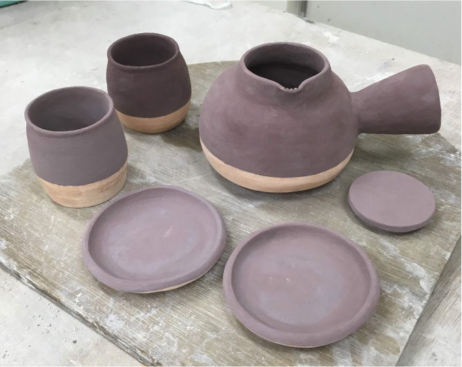 Tea set after glazing, before glazing fire.