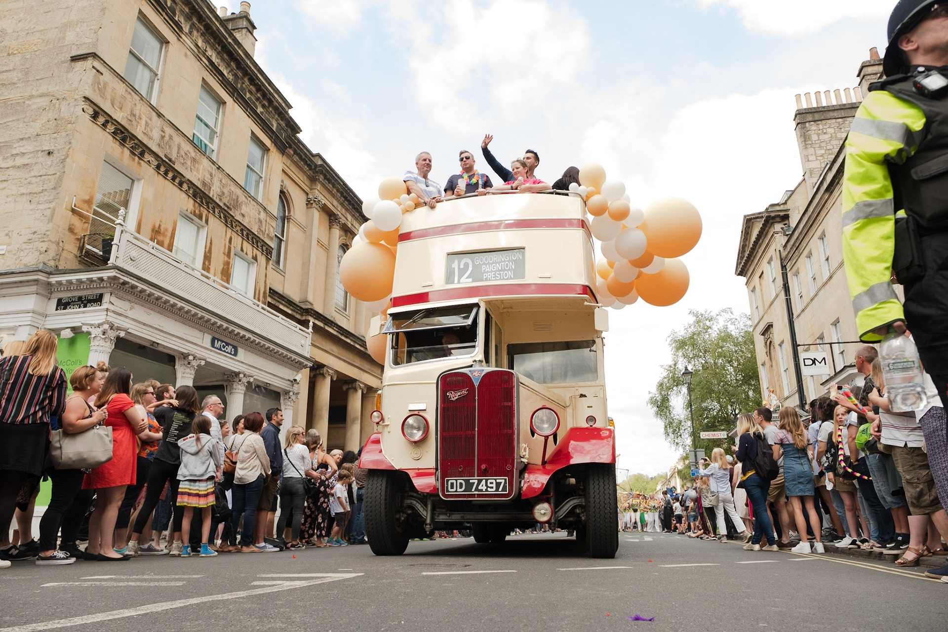 Pictured: A classic bus takes part of the 2019 Bath Carnival Parade whilst passengers enjoy a unique view of the celebrations. Saturday July 13th, Pultney Bridge, Bath, UK