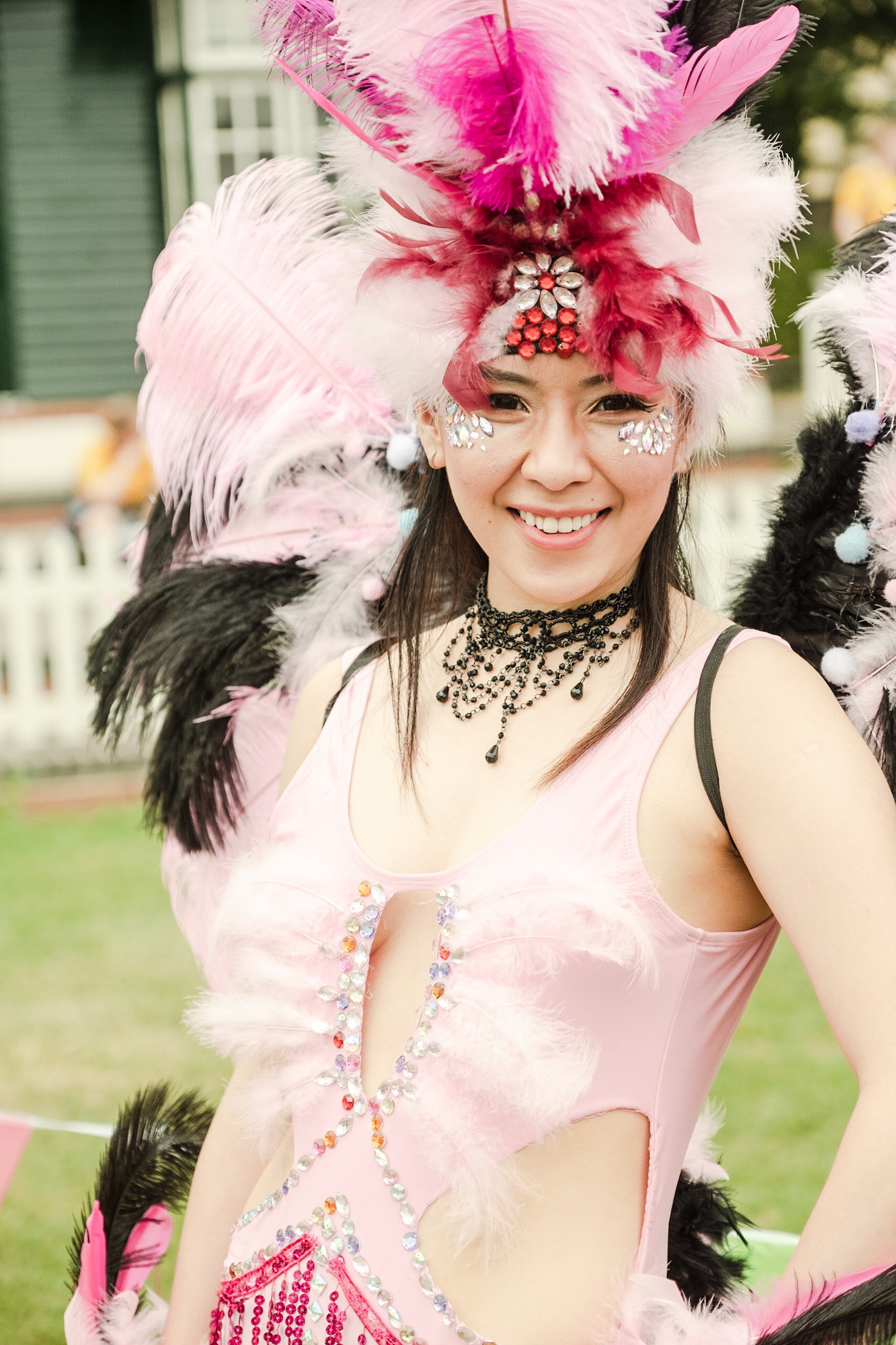 Pictured: Michelle from Flaming Feathers show-girls group, preparing for the main parade. Bath Recreation Ground, Bath UK, Saturday 13th of July.