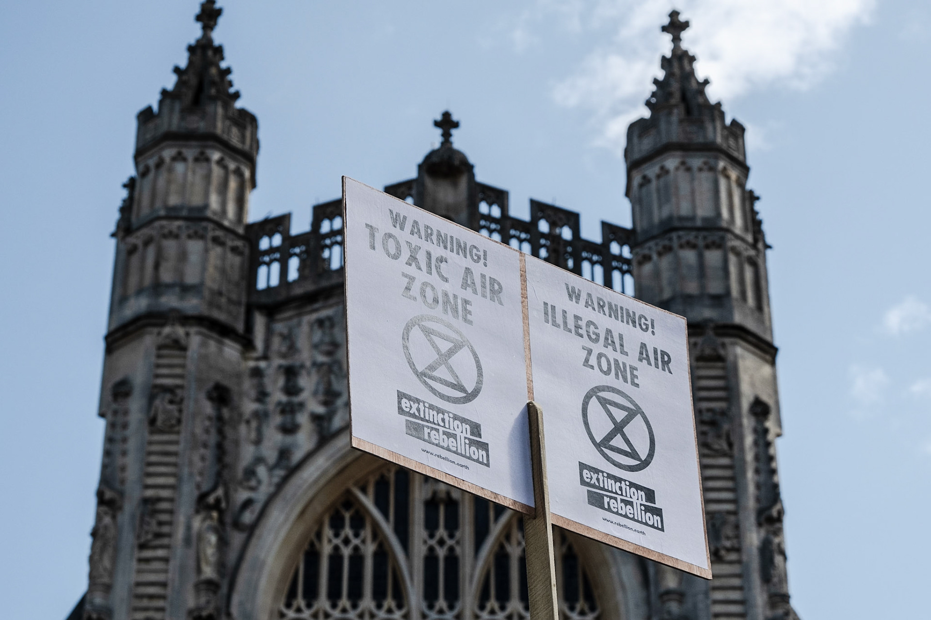 placards and signs are visable throughout the protest, reading statements about the ongoing health issues caused by polution . Bath 17,08,19