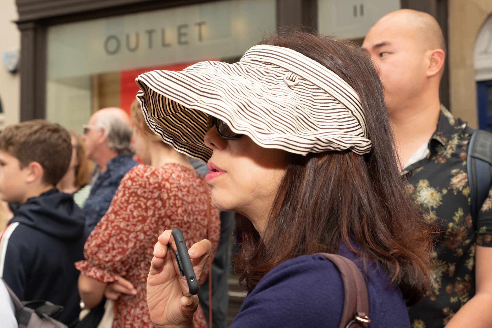 Pictured: International tourists that visit Bath throughout the summer took time to enjoy the Carnival celebrations Saturday 13th of July 2019, Pultney Bridge, Bath, UK