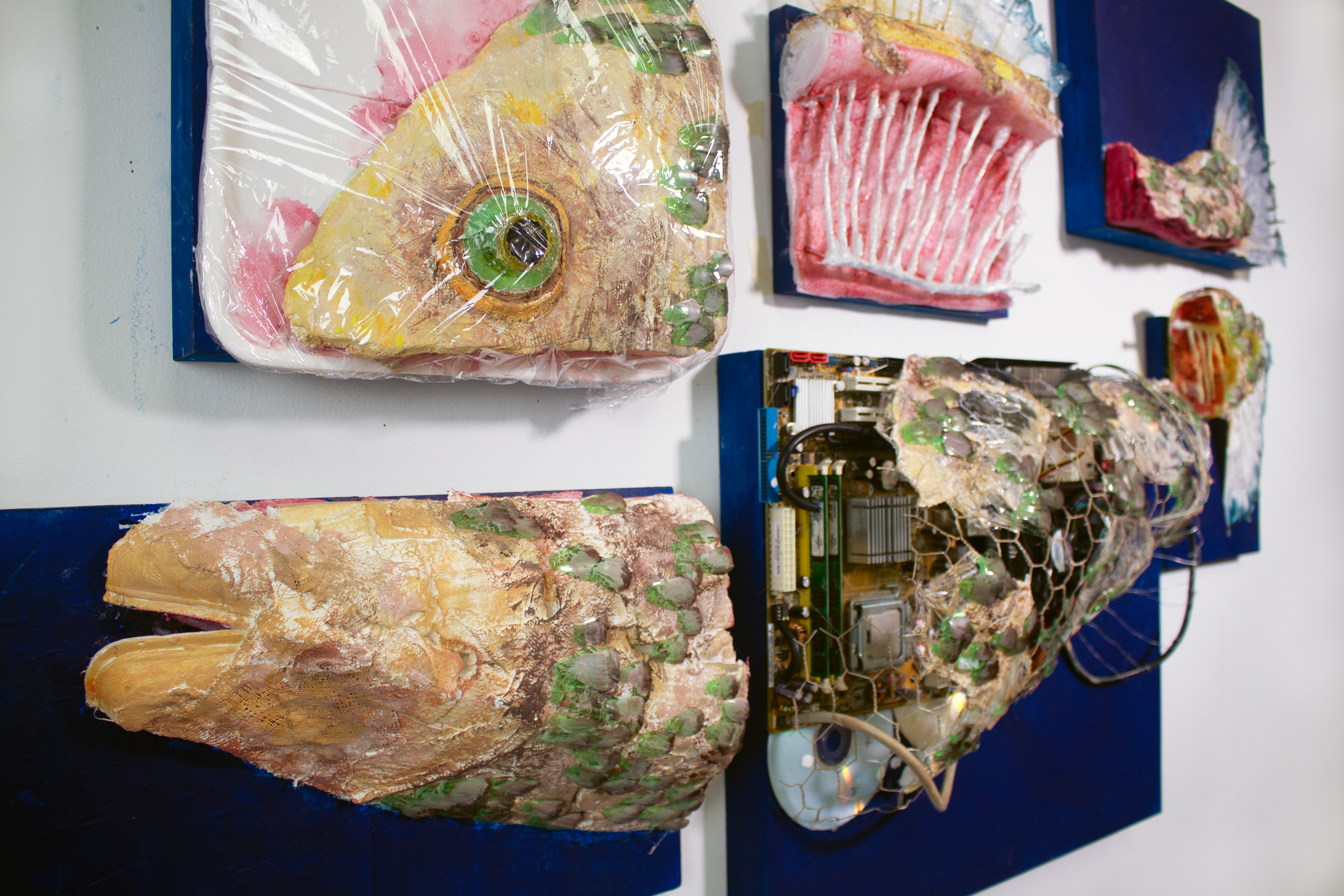 Acrylic paint on wooden panels, plaster, found Items: plastic, foam, wire, bottles, receipts, circuitboards, zipties, CD’s.