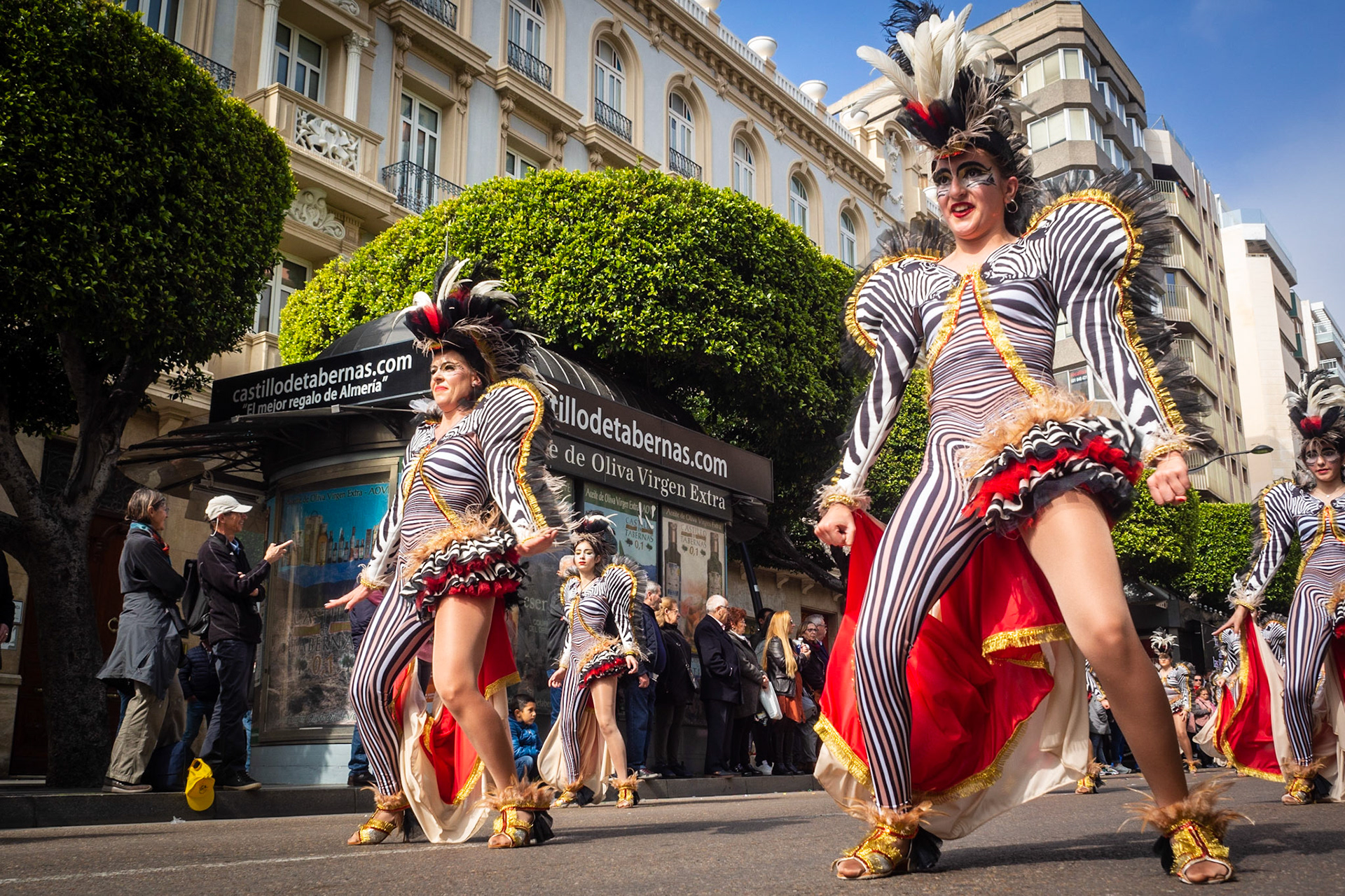 Girls in flamboyant carnival dress at The Almeria Carnival Parade, Spain.