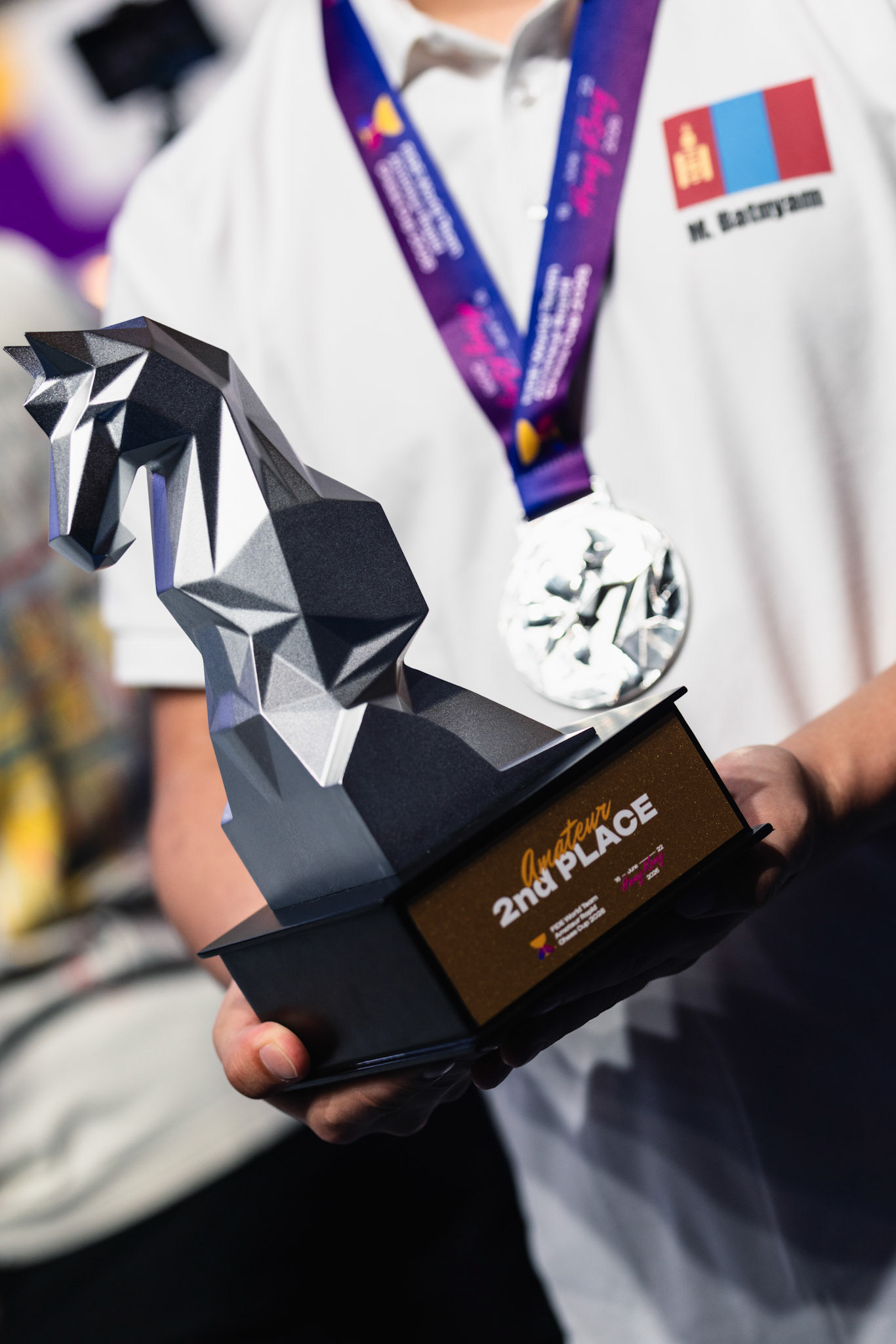 HONG KONG, China - JUNE 21: Player of Mongolia shows the trophy and silver medal during FIDE World Team Amateur Rapid Chess Cup 2026 at Queen Elizabeth Stadium on June 21, 2026 in Hong Kong, China, (Photo by Jack Ng/Alamy Live News)